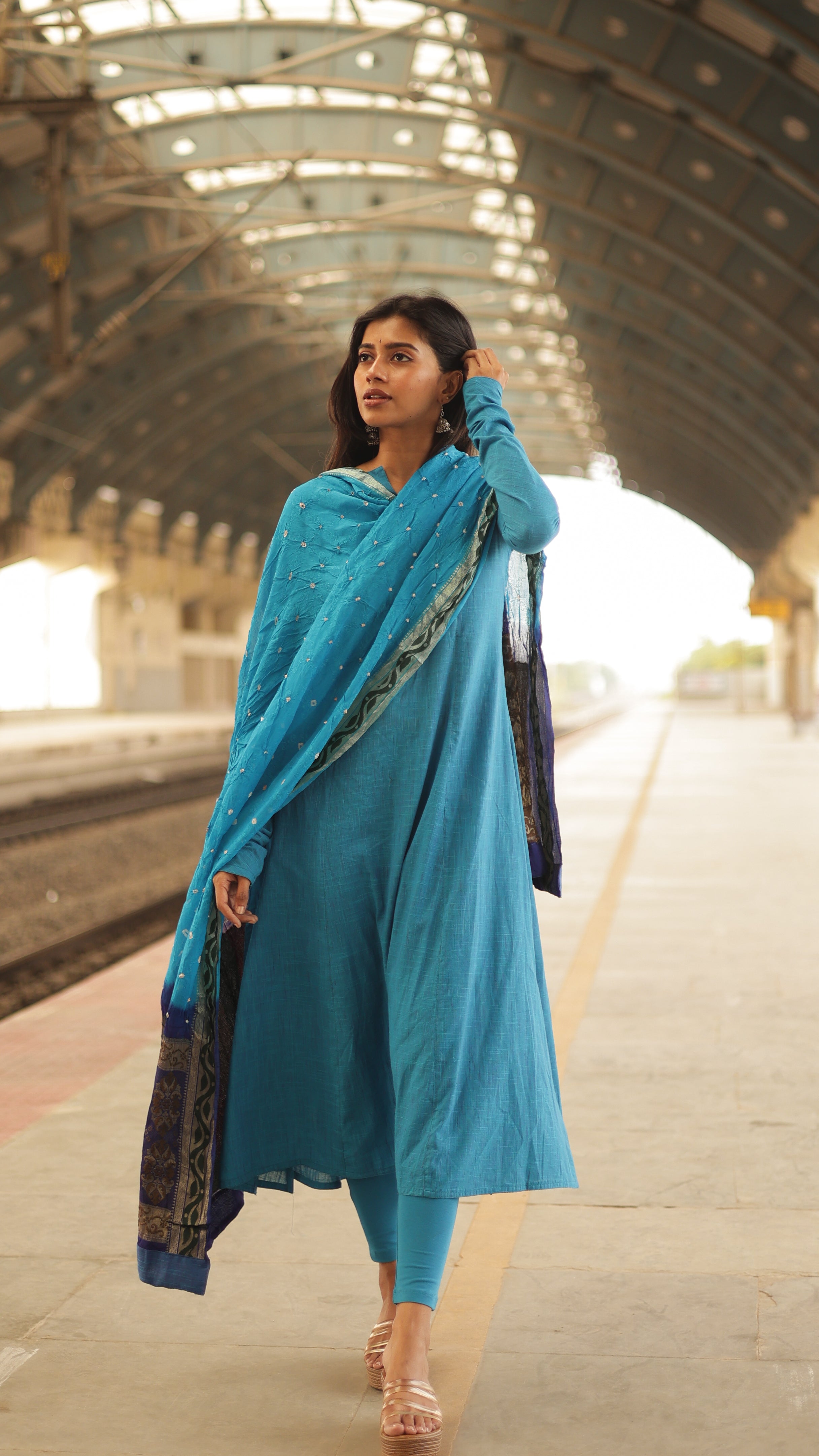 A soft cotton dupatta in a neutral bandini shades, elegantly framed with a vibrant zari border