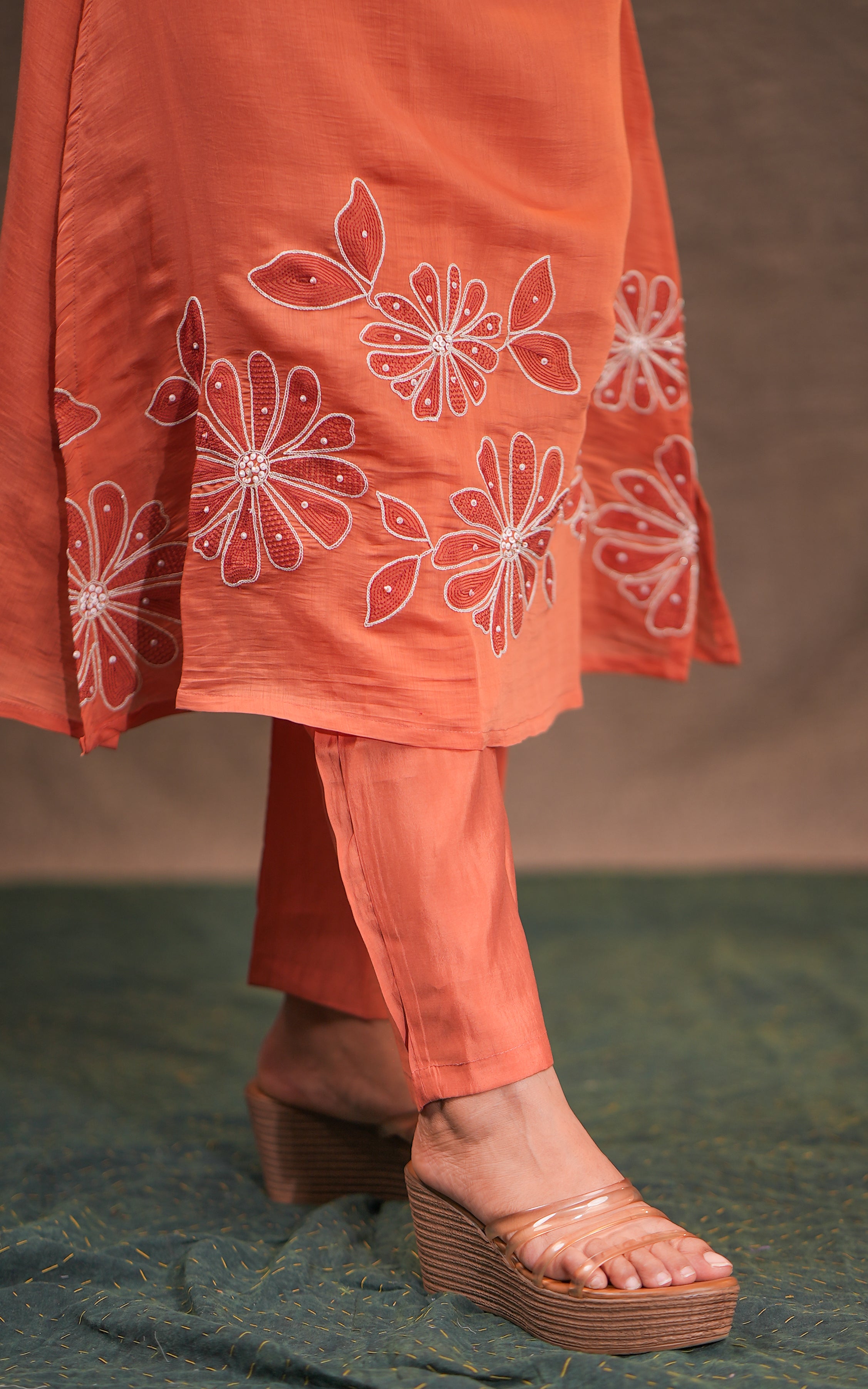 Orange outfit with floral embroidery
