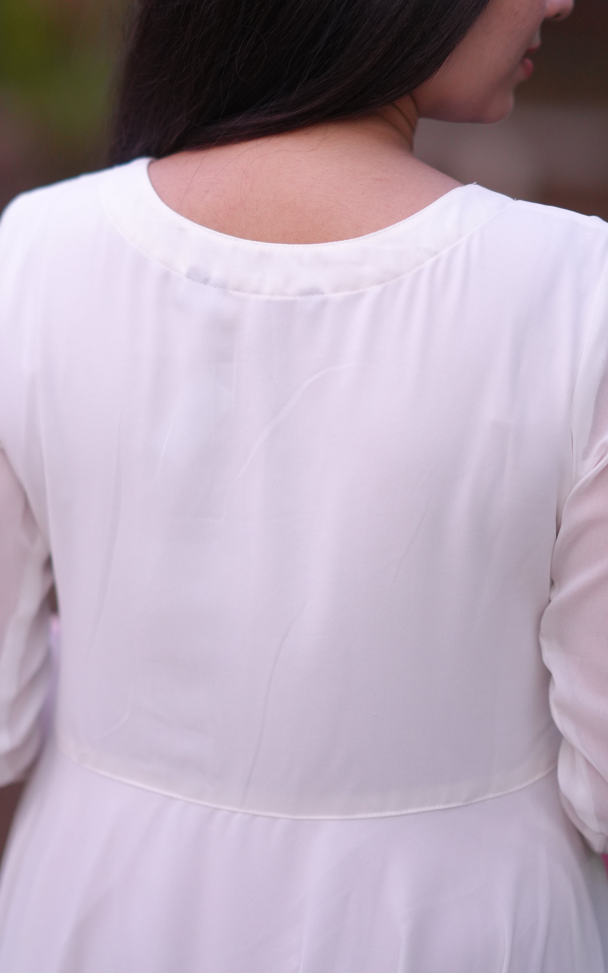Back neckline features a modest round shape