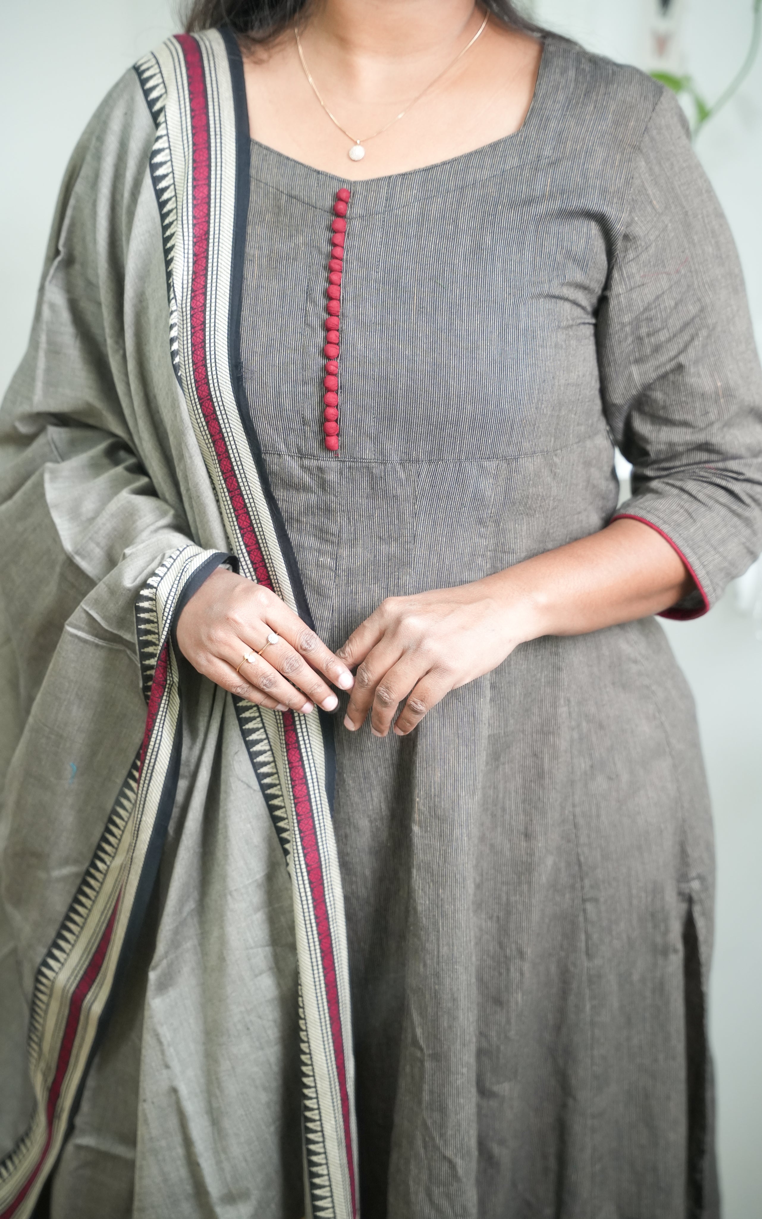 Traditional South Cotton A-line kurti in black, styled with a grey dupatta adorned with maroon borders for a refined ethnic ensemble