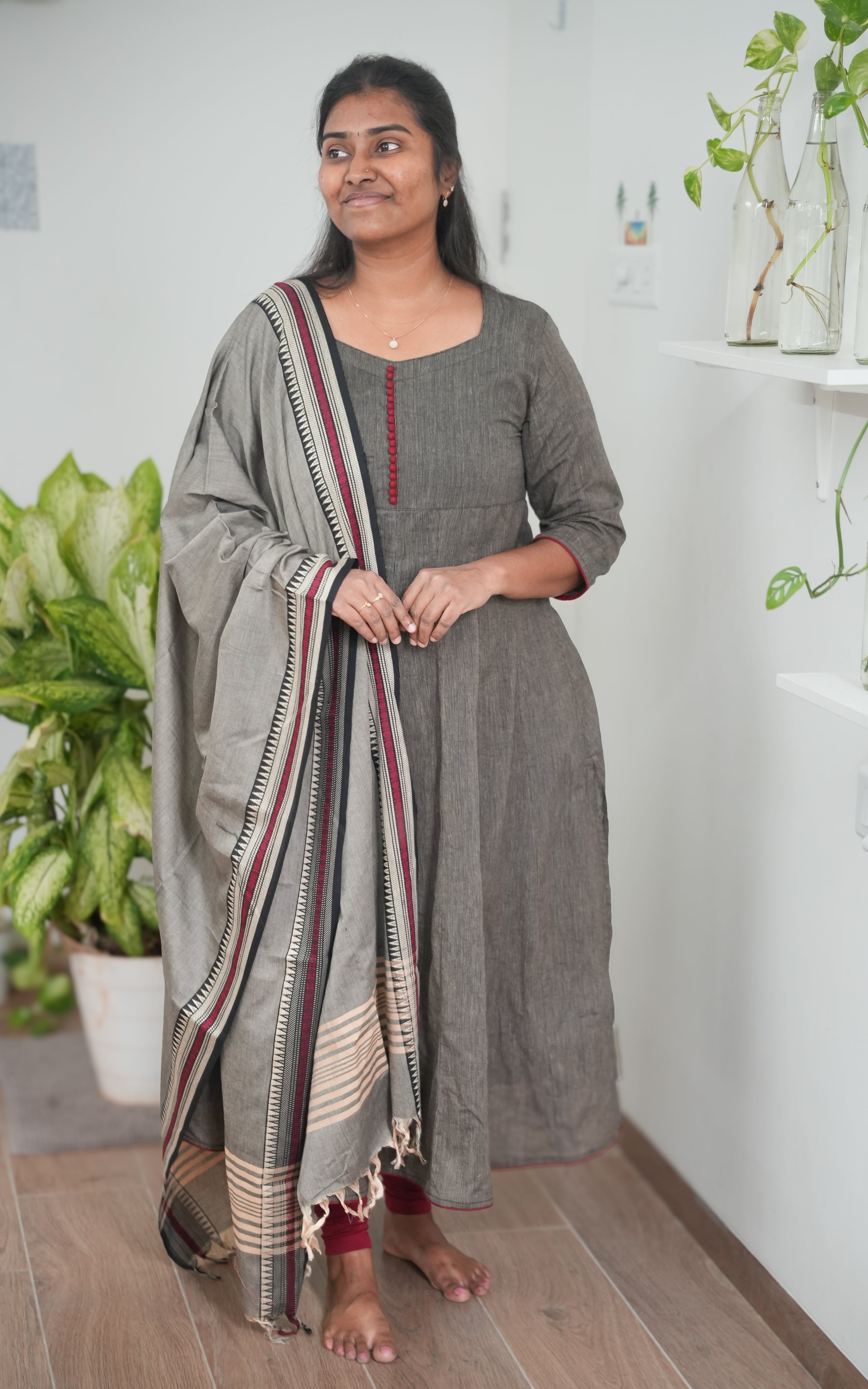 Comfortable South Cotton A-line kurti in black, enhanced by a grey dupatta with elegant maroon border accents for festive and casual wear.