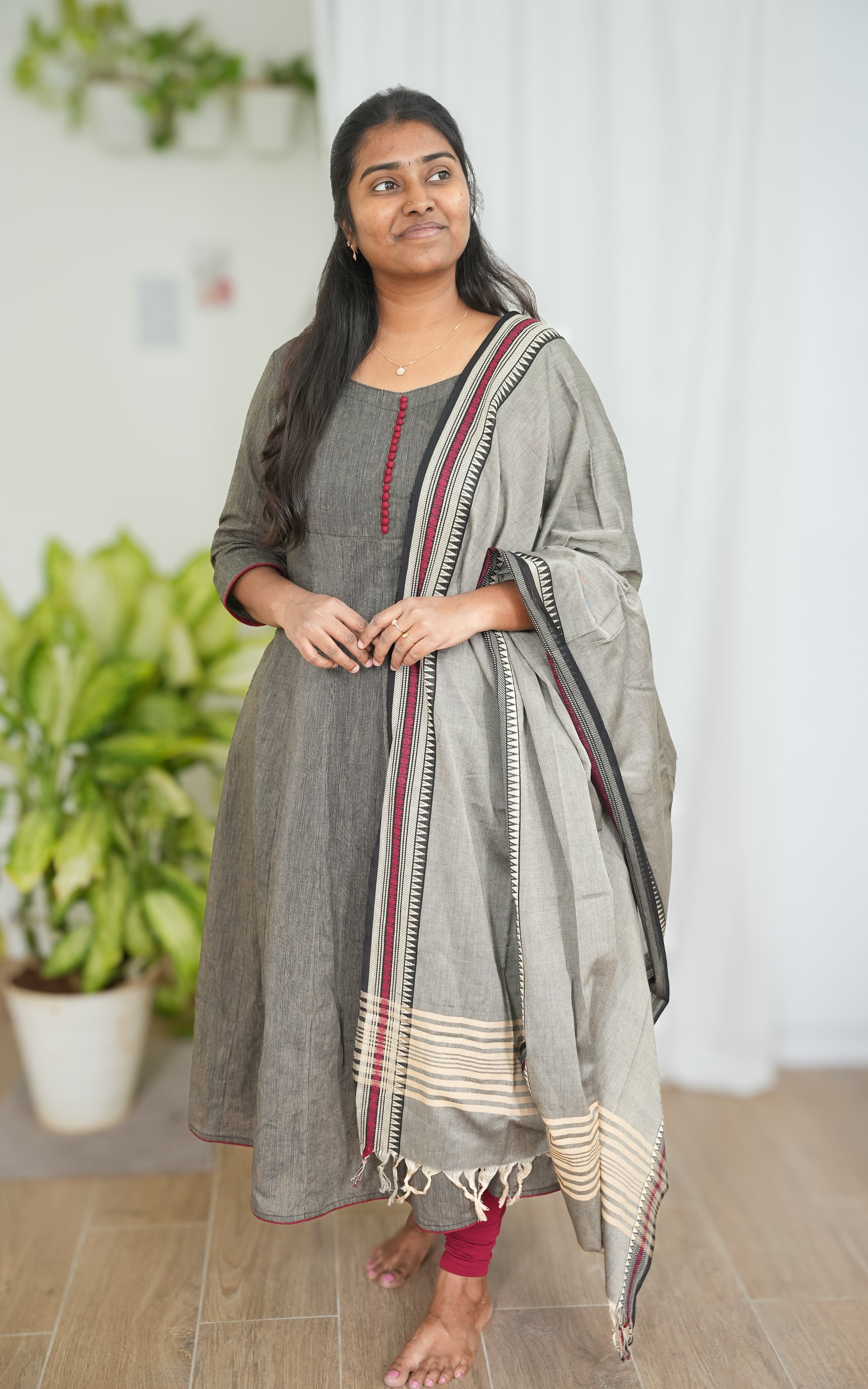 Black South Cotton kurti in an A-line cut with side slit, completed with a grey dupatta detailed with maroon borders for a graceful ethnic outfit