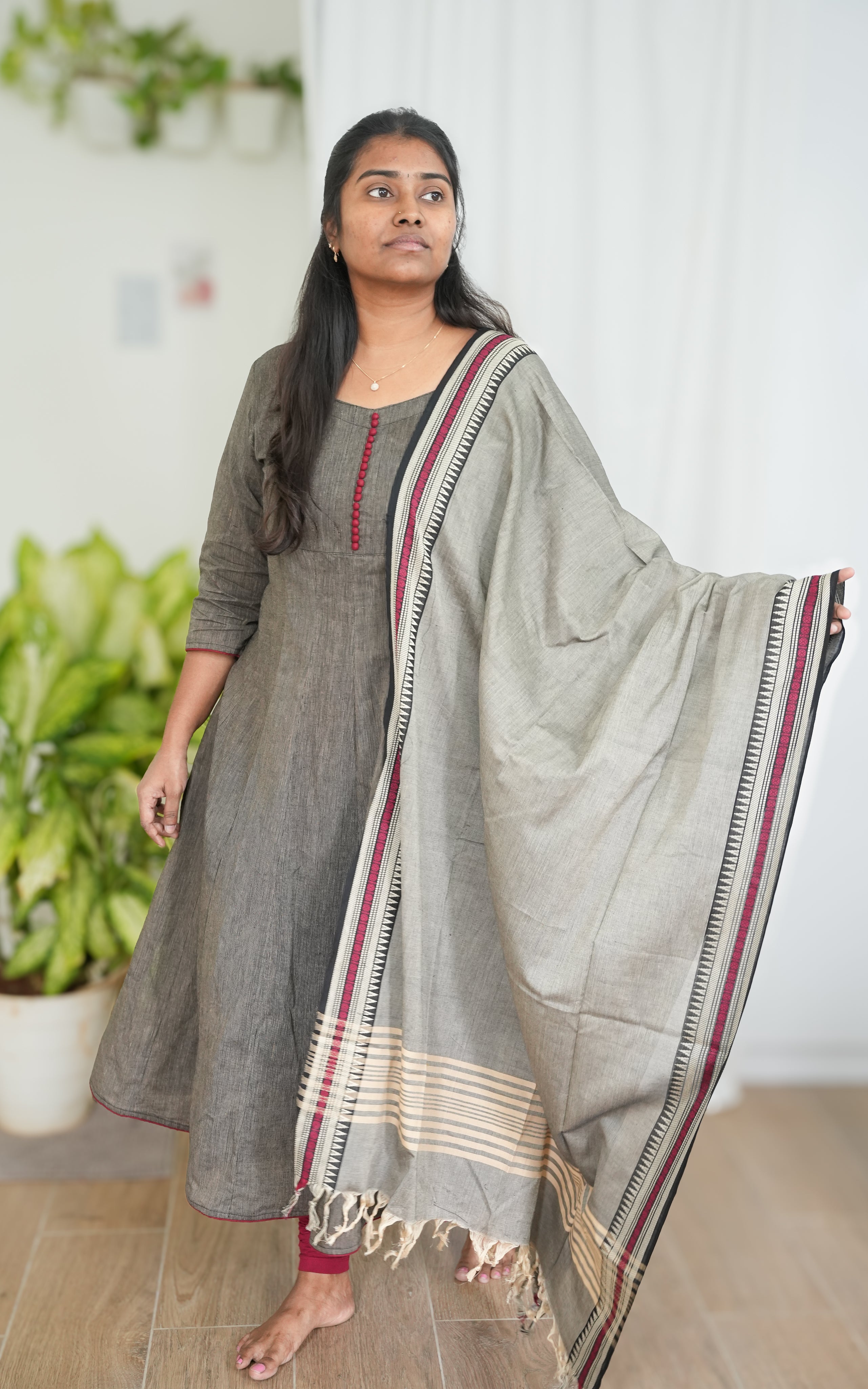 Black South Cotton A-line kurti with side slit, paired with a grey dupatta featuring elegant maroon borders for a sophisticated ethnic look