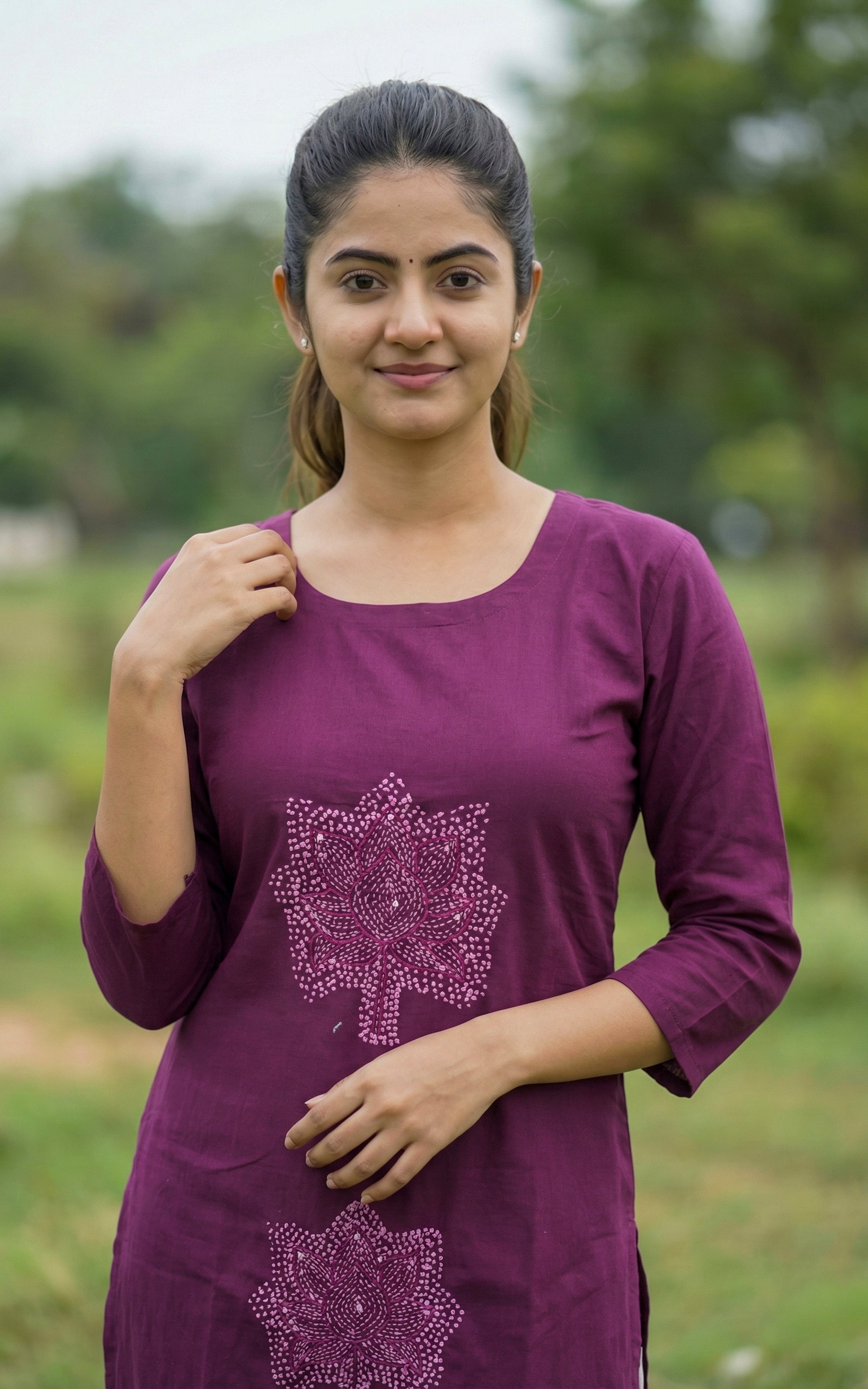 Woman wearing a purple dress with a floral design