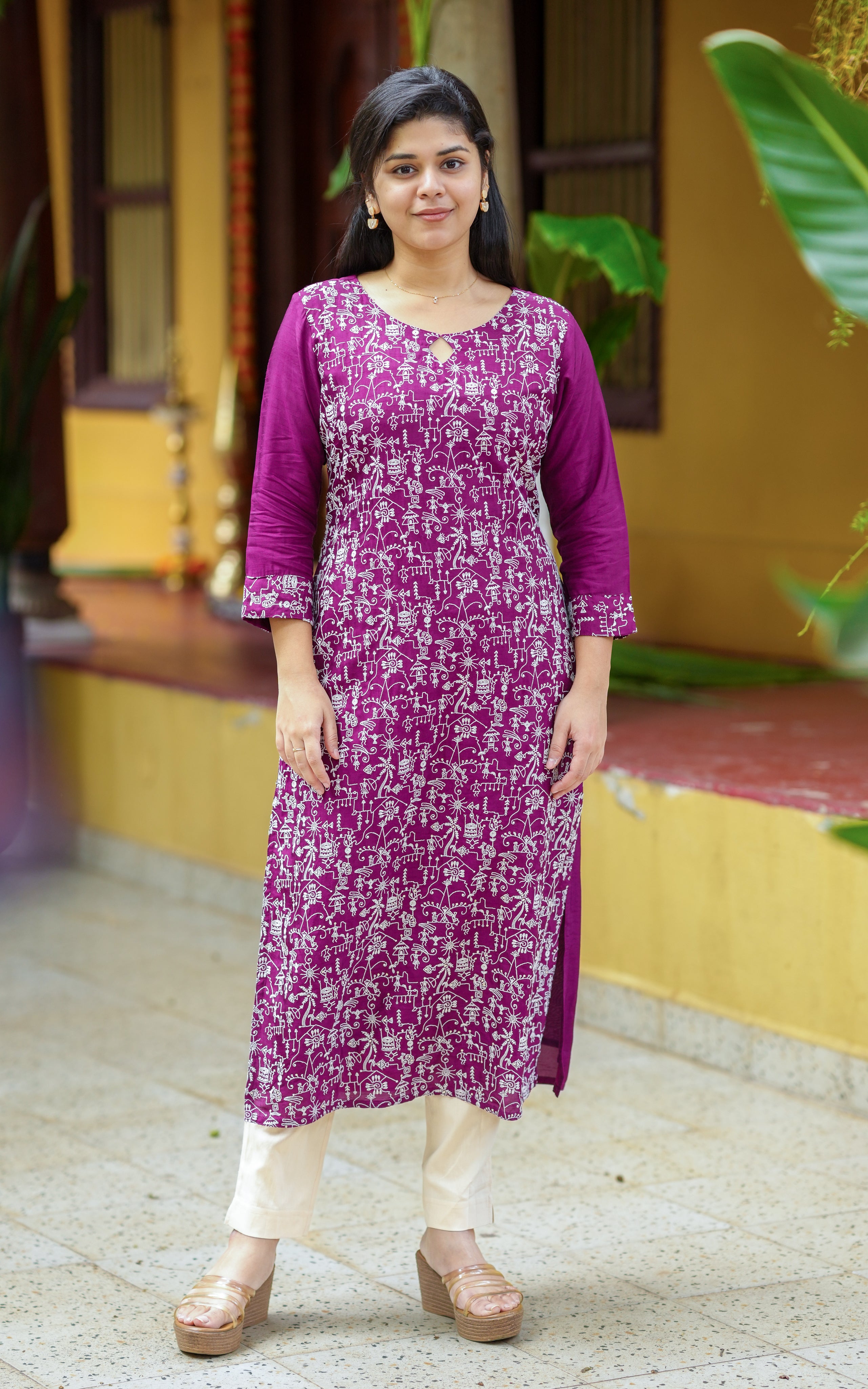 Woman wearing a purple straight cut kurti