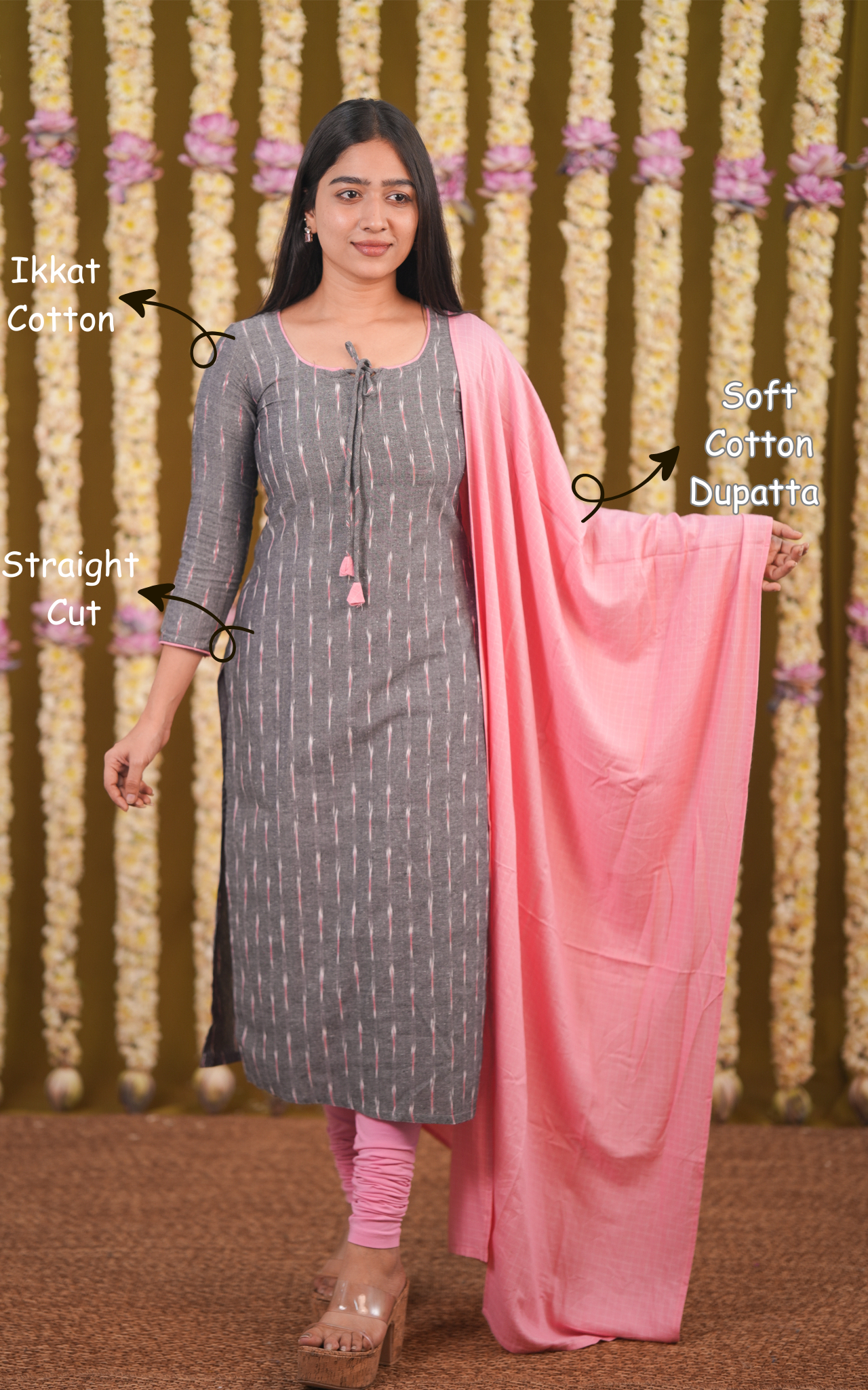 Woman wearing a gray kurta with pink dupatta against a decorative background