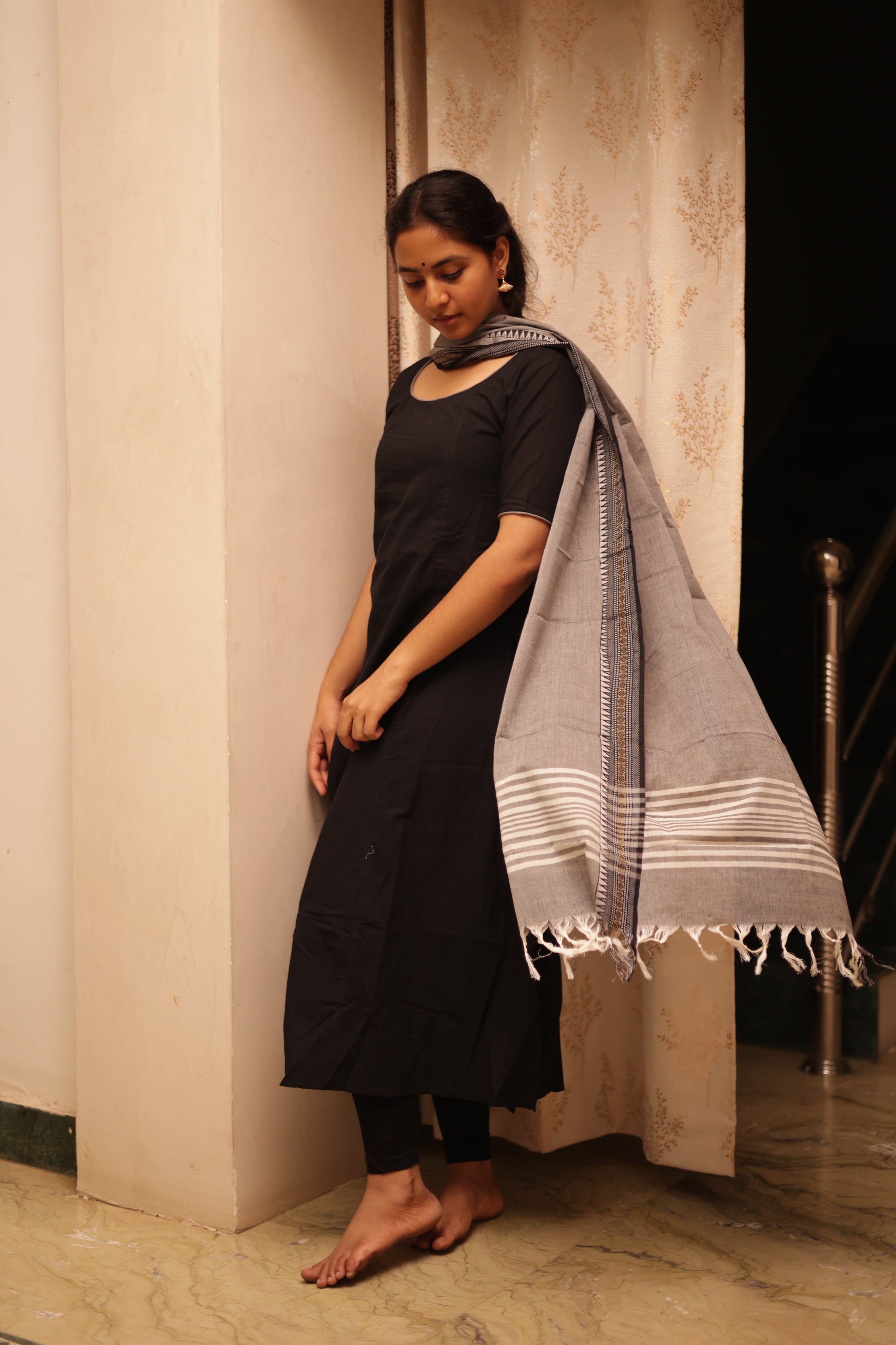 handloom cotton dupatta adds a touch of tradition, enhancing the overall elegance of the outfit.