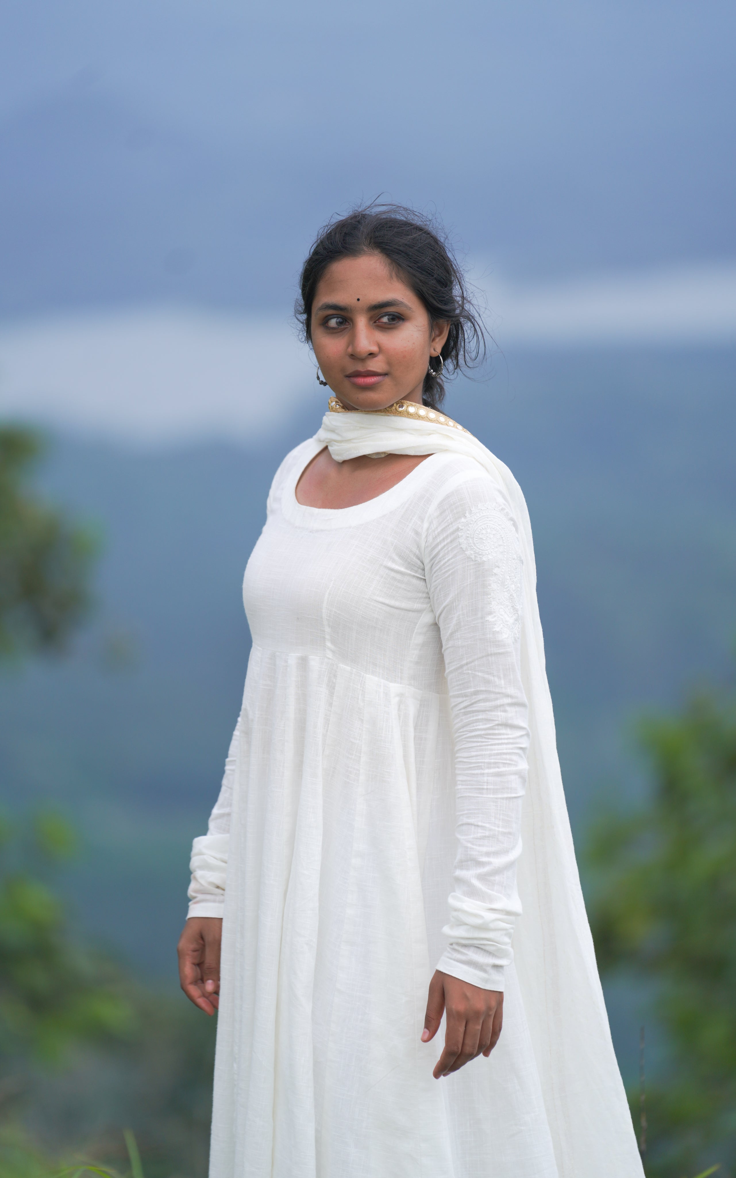 woman in white long dress on hilltop, inspired by Raavanan movie