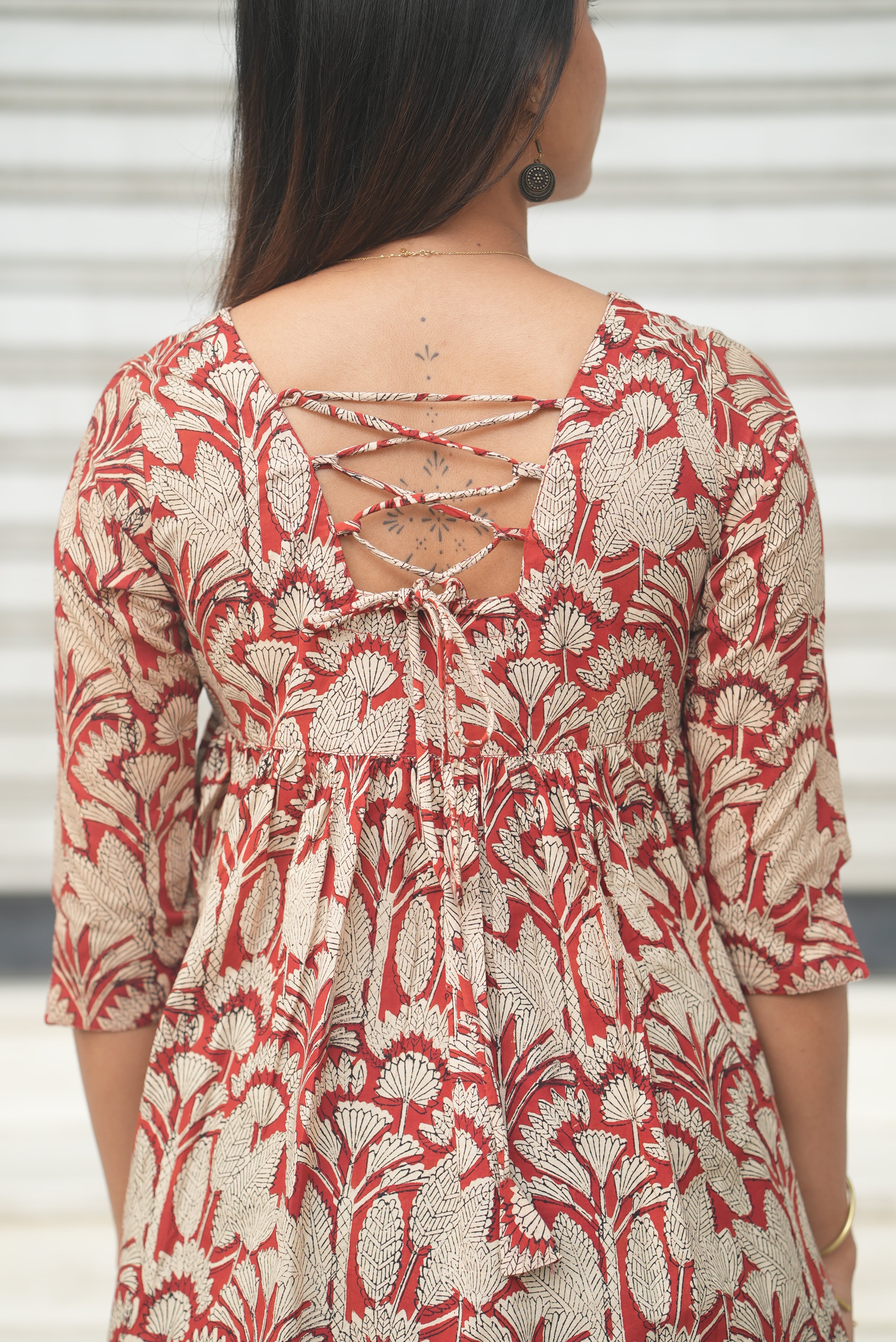 Rust A-line cotton short kurti with traditional block print.cotton short kurti with back neck rope detail.