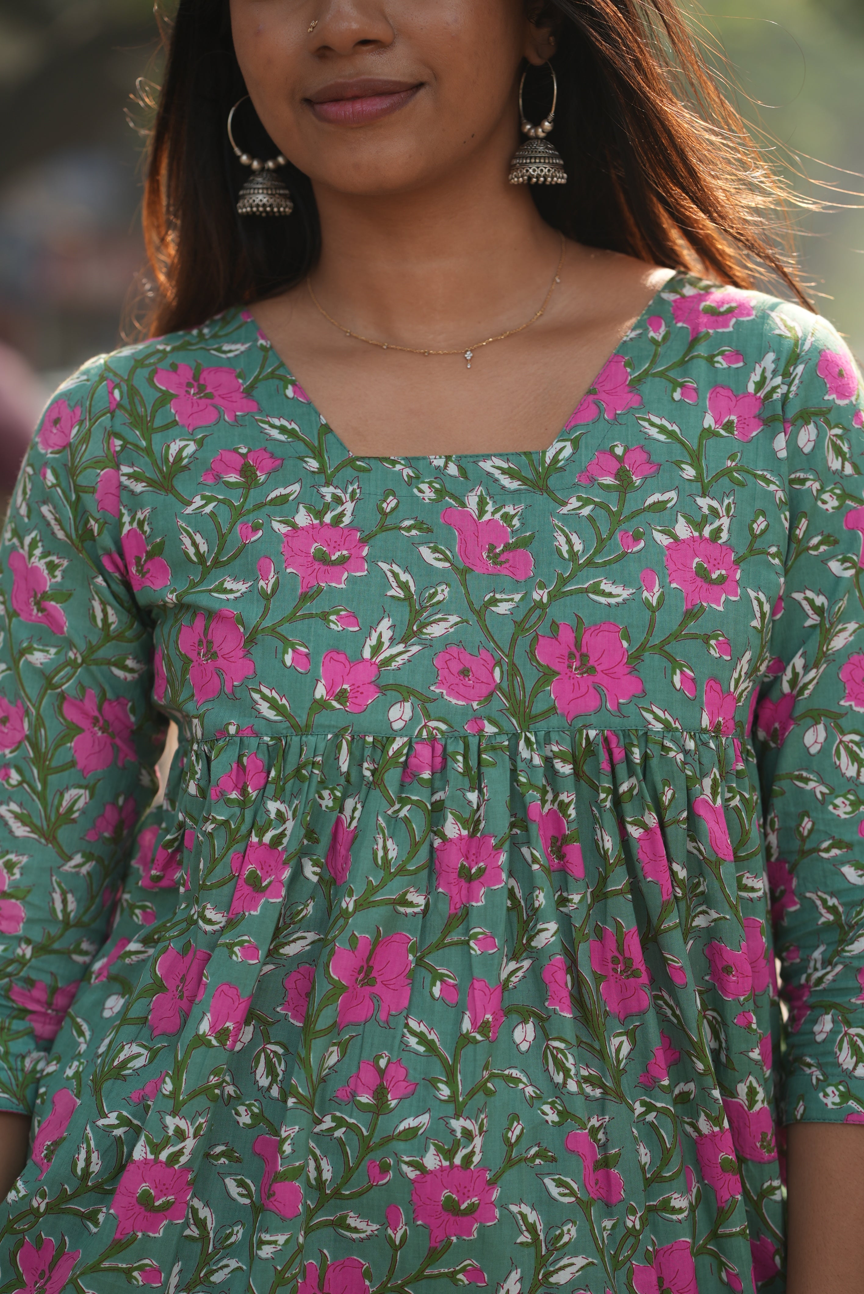 Green cotton short kurti with back neck rope detail.