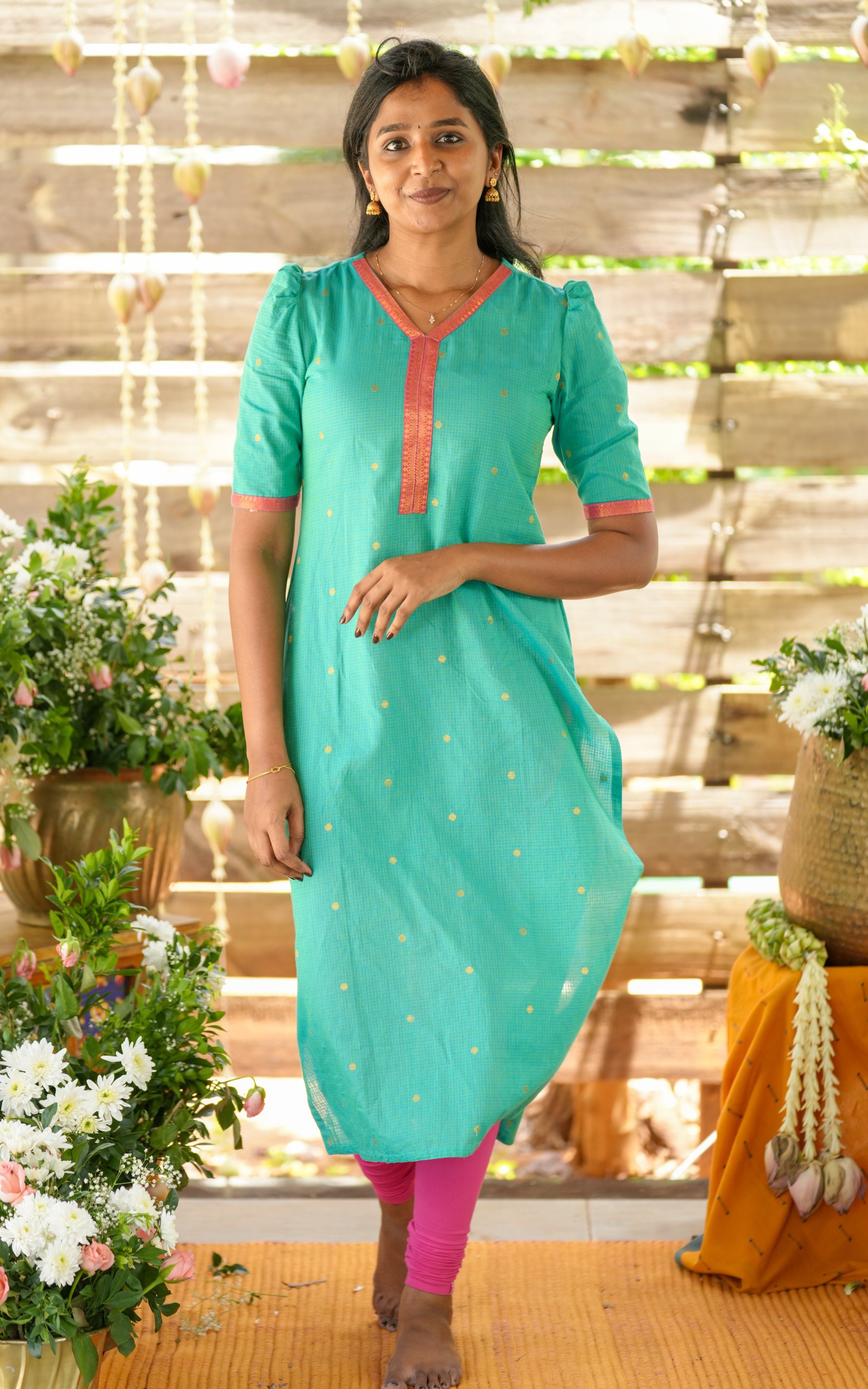 Simple straight-cut kurti with small golden embroidery dots – neat and elegant.
