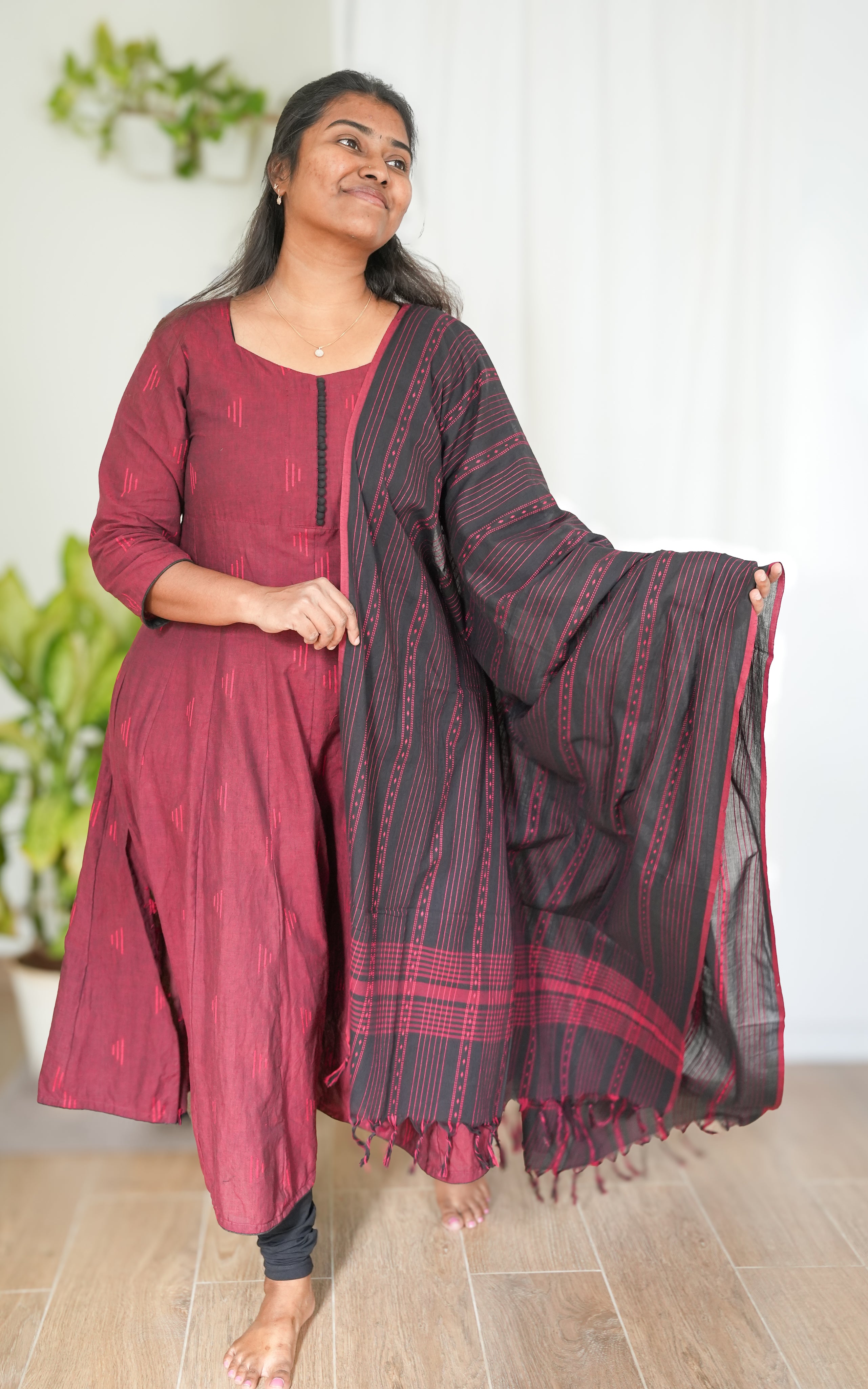 Maroon South Cotton A-line kurti with side slit, paired with a black dupatta featuring elegant borders for a striking ethnic look