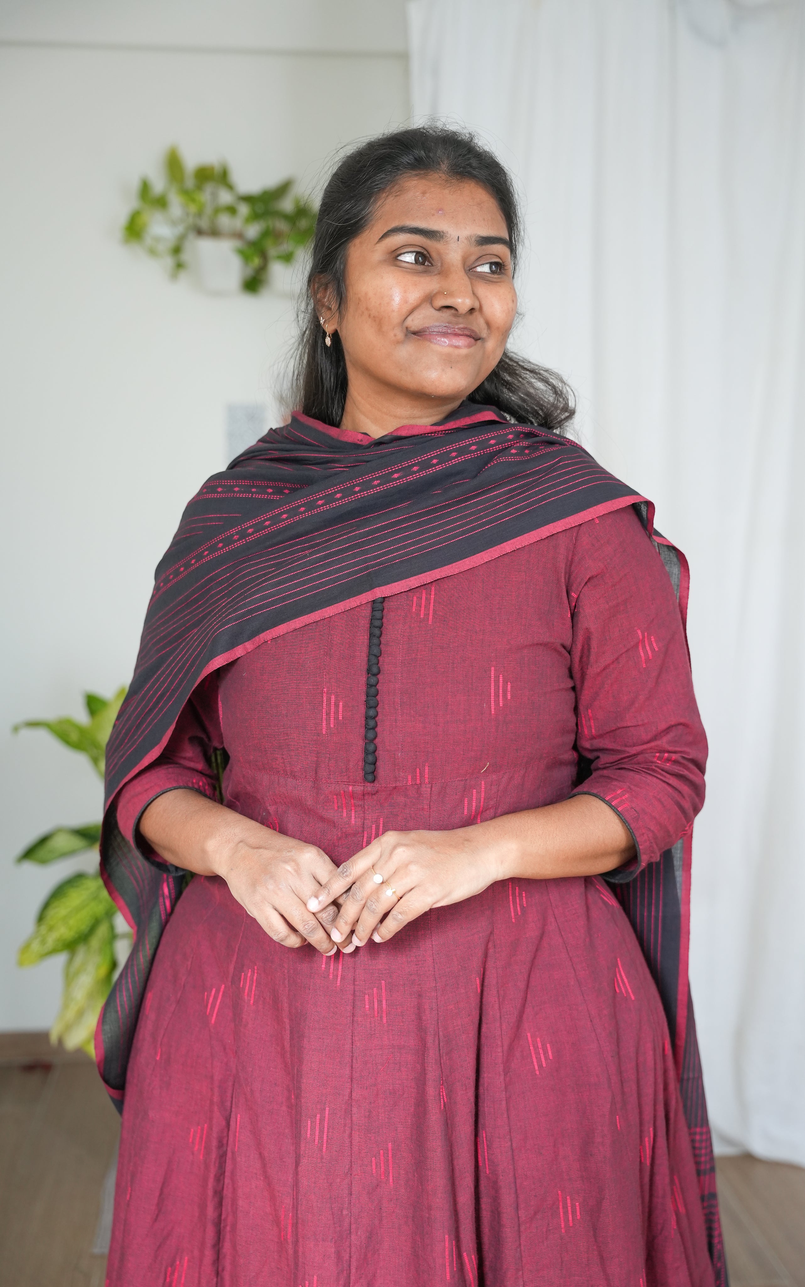 A-line kurti in rich maroon South Cotton, complemented by a black dupatta with subtle border detailing, perfect for festive occasions