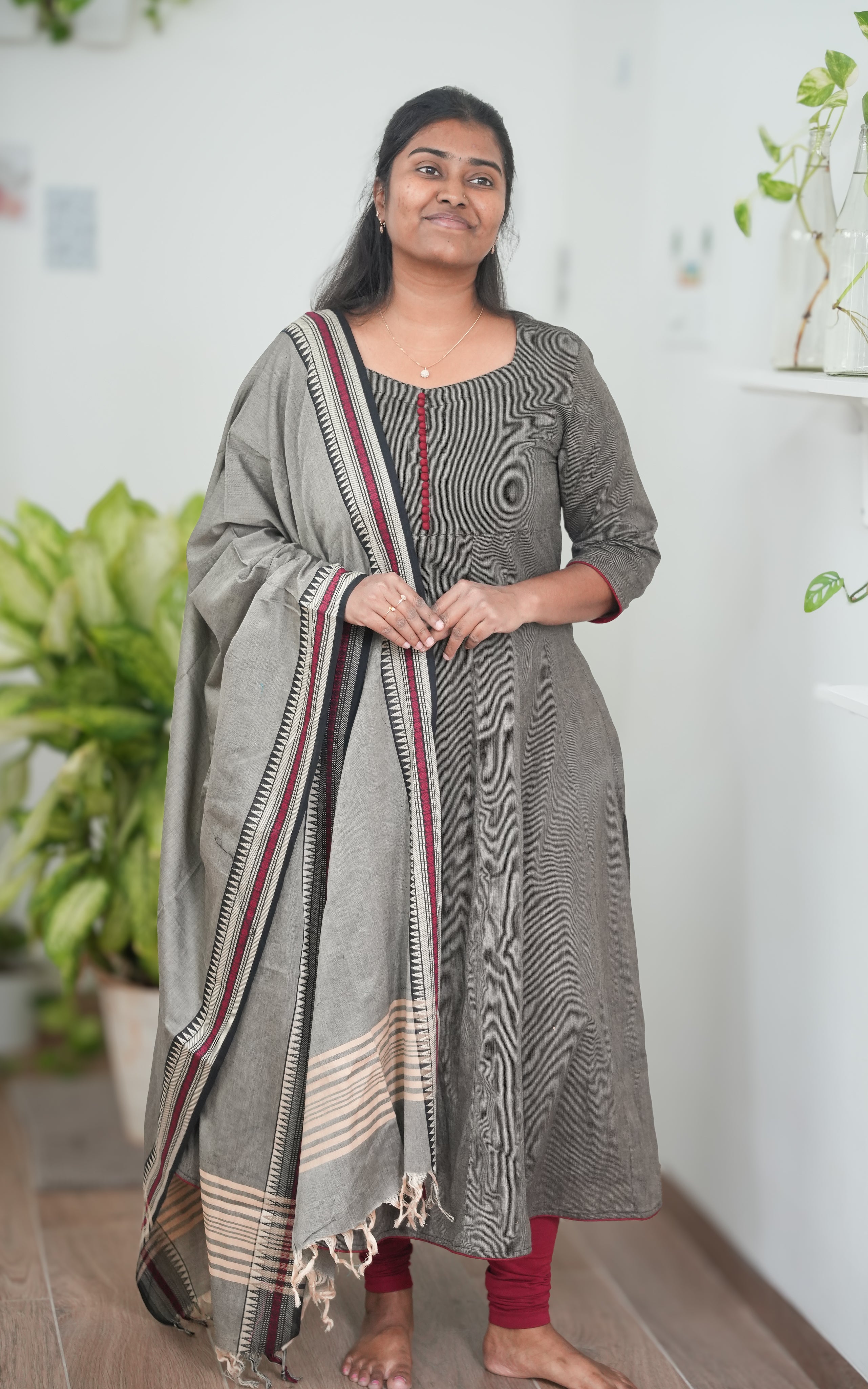 A-line kurti in soft black South Cotton, complemented by a grey dupatta with striking maroon border detailing, perfect for festive occasions