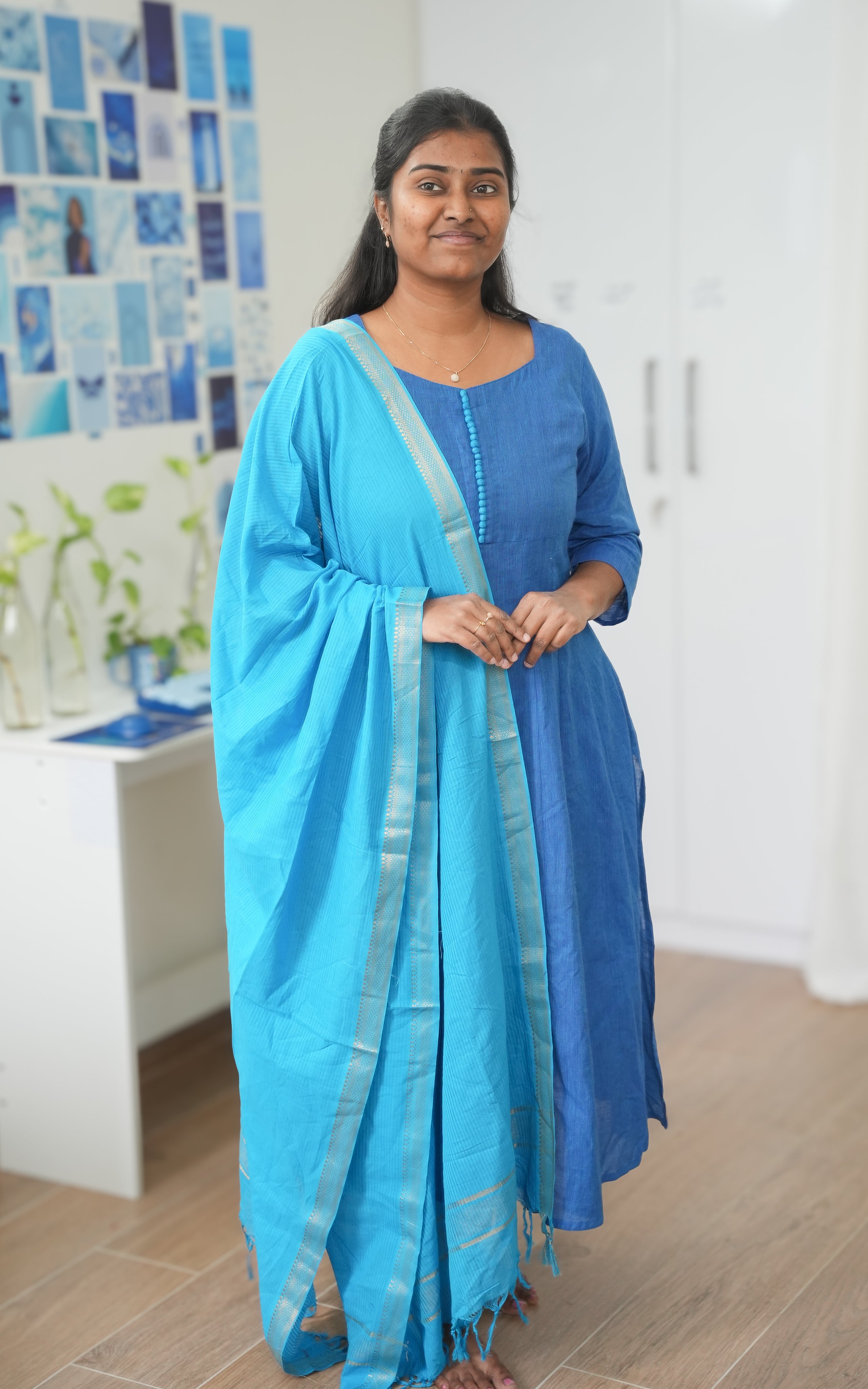 Blue South Cotton A-line kurti with side slit, featuring a delicate sweetheart neckline at the front, round back neck, and decorative potli buttons, paired with a matching sky blue dupatta
