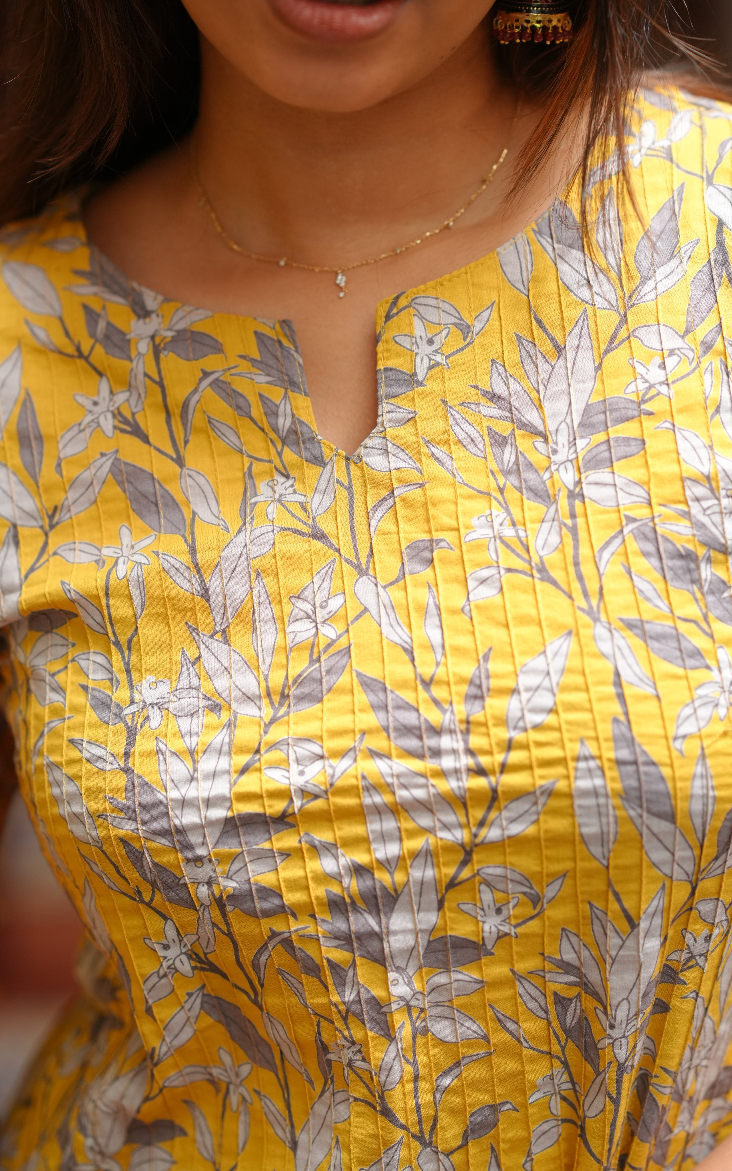 The printed design in grey and white contrasts beautifully with the vibrant yellow base.