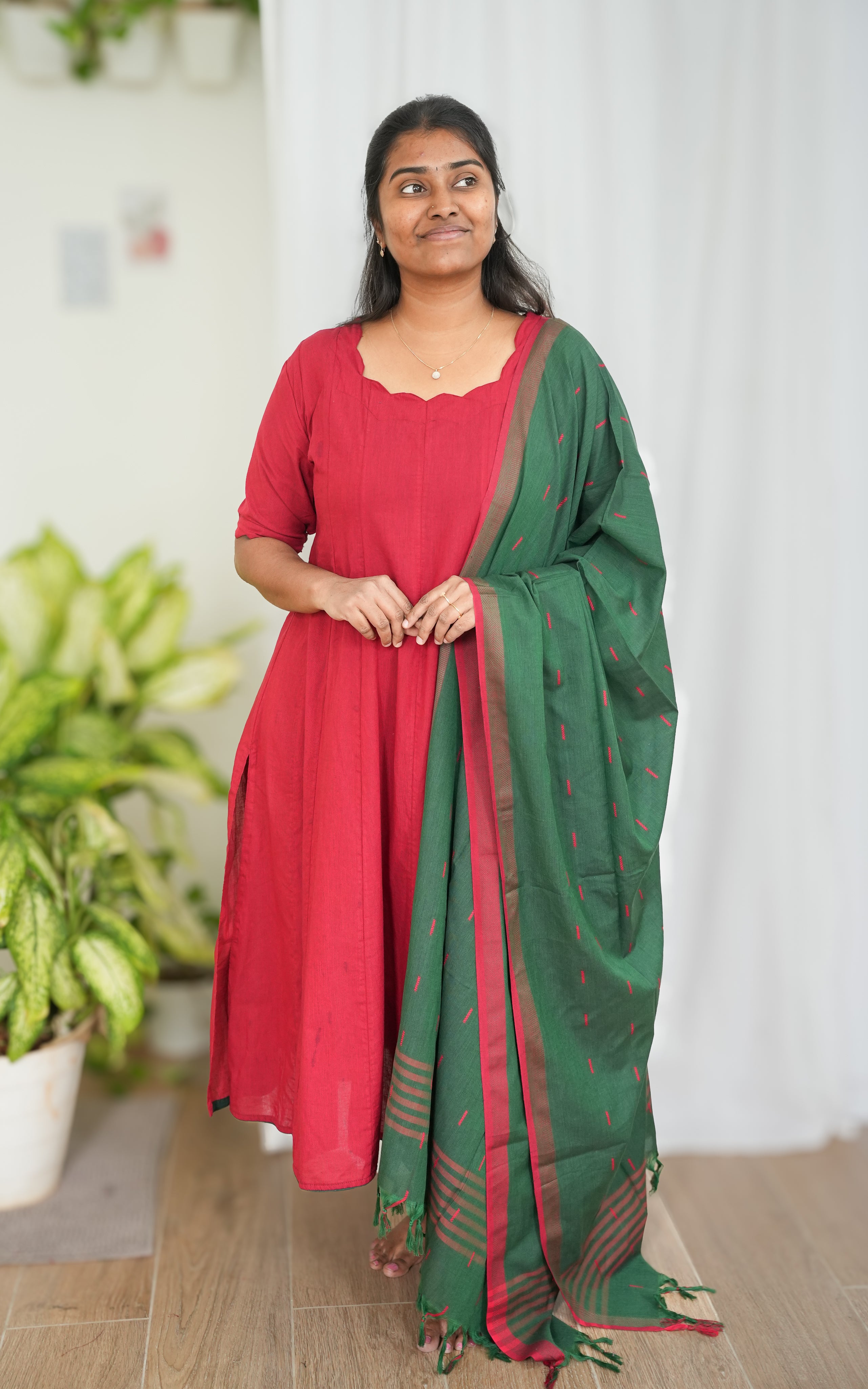 Red South Cotton A-line kurti with side slit, paired with a green dupatta featuring elegant border detailing for a vibrant ethnic look