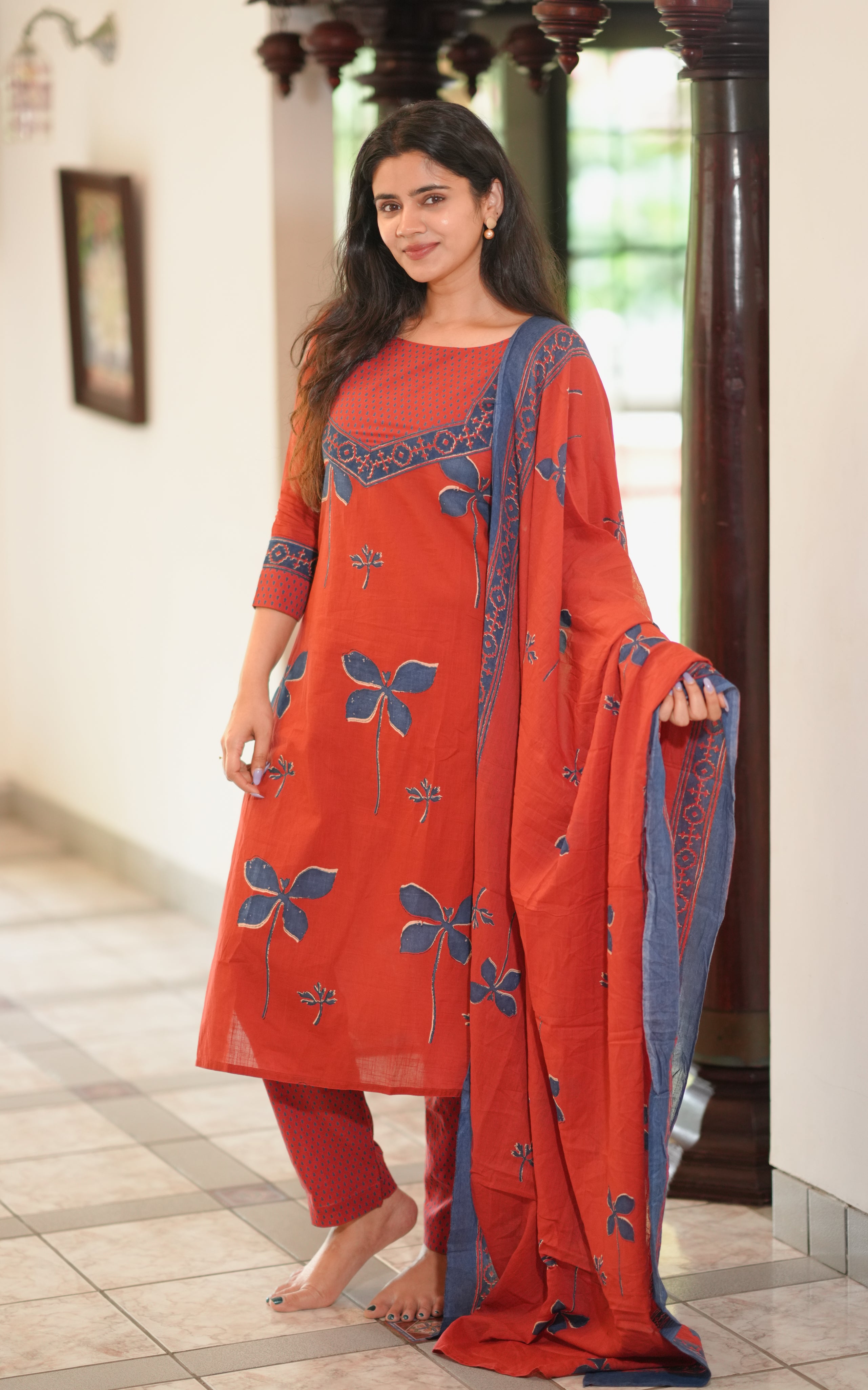 The kurti features blue floral motifs and a dotted print yoke.