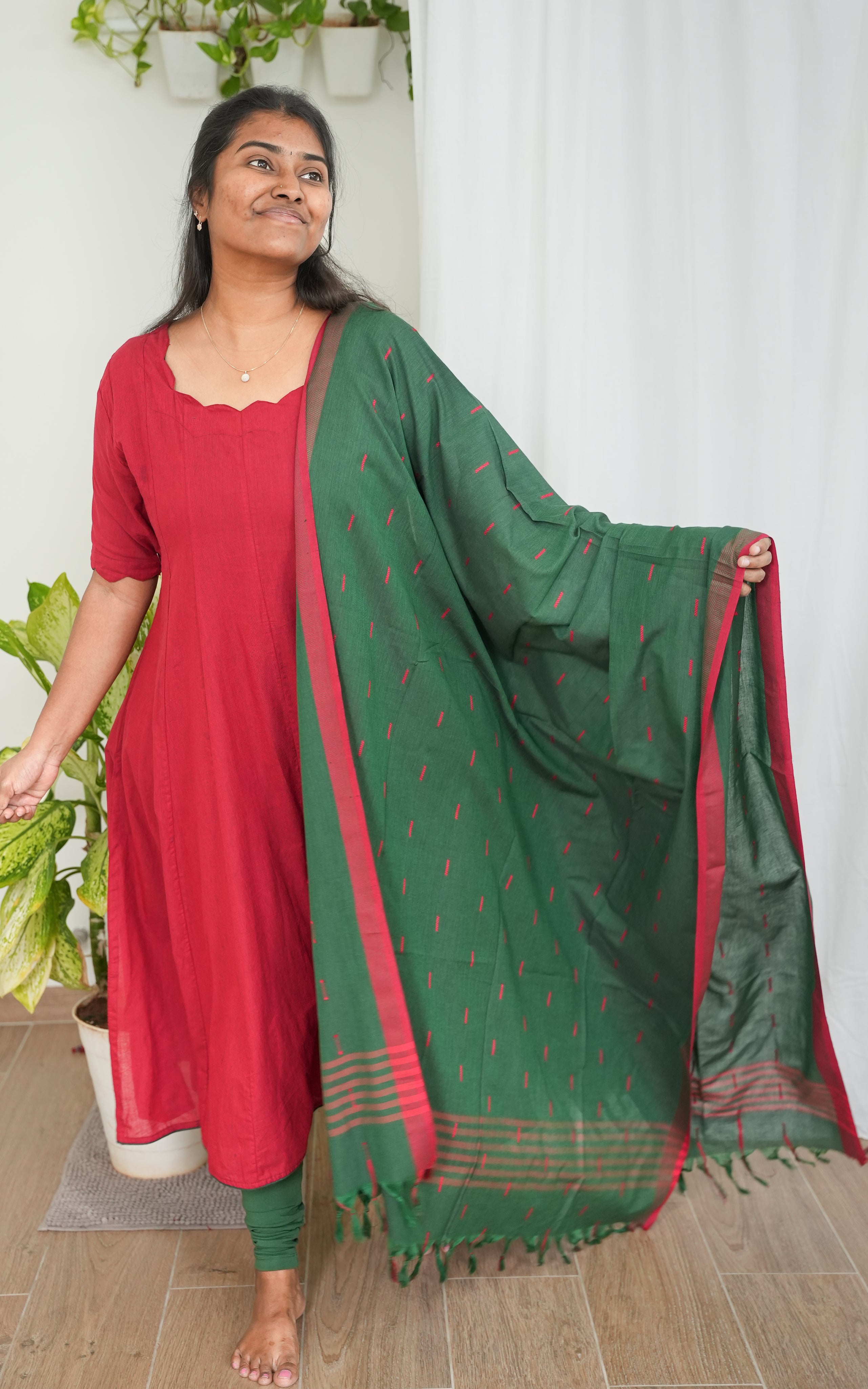 A-line kurti in bold red South Cotton, complemented by a rich green dupatta with subtle borders, perfect for festive occasions and celebrations