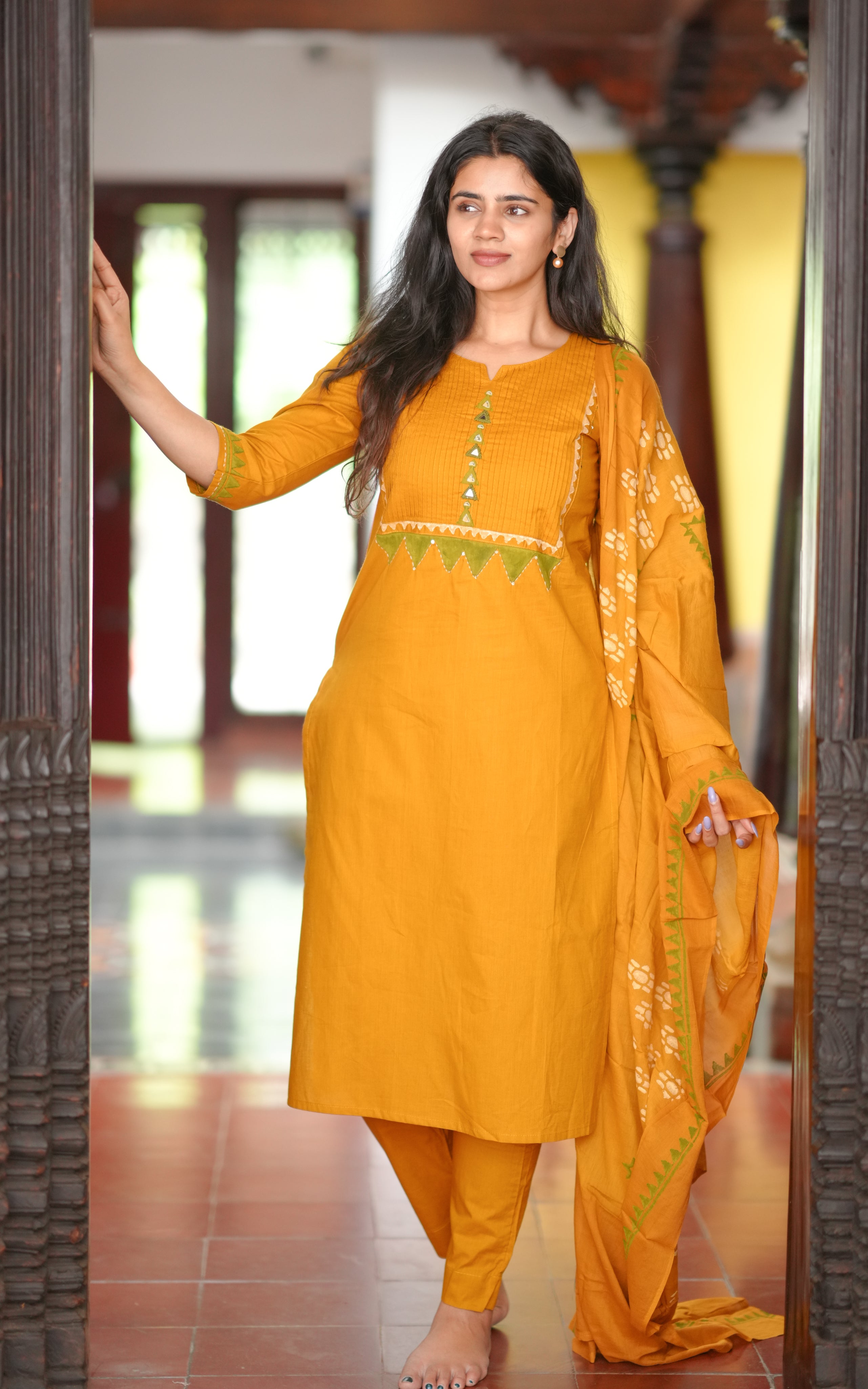 The mustard yellow color adds a warm and festive feel to the ensemble.