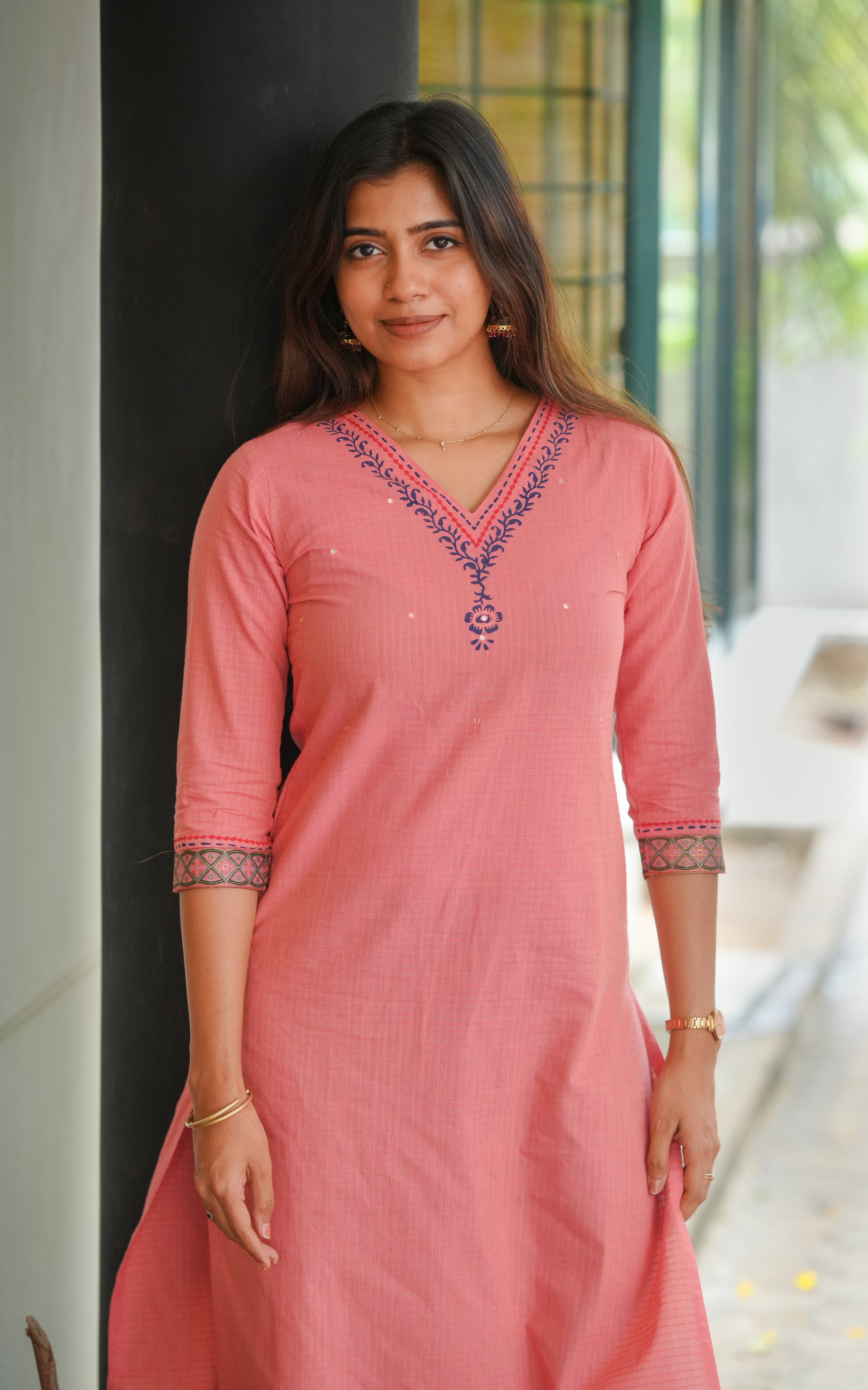 Straight cut kurti with stylish side slits for comfort and movement.