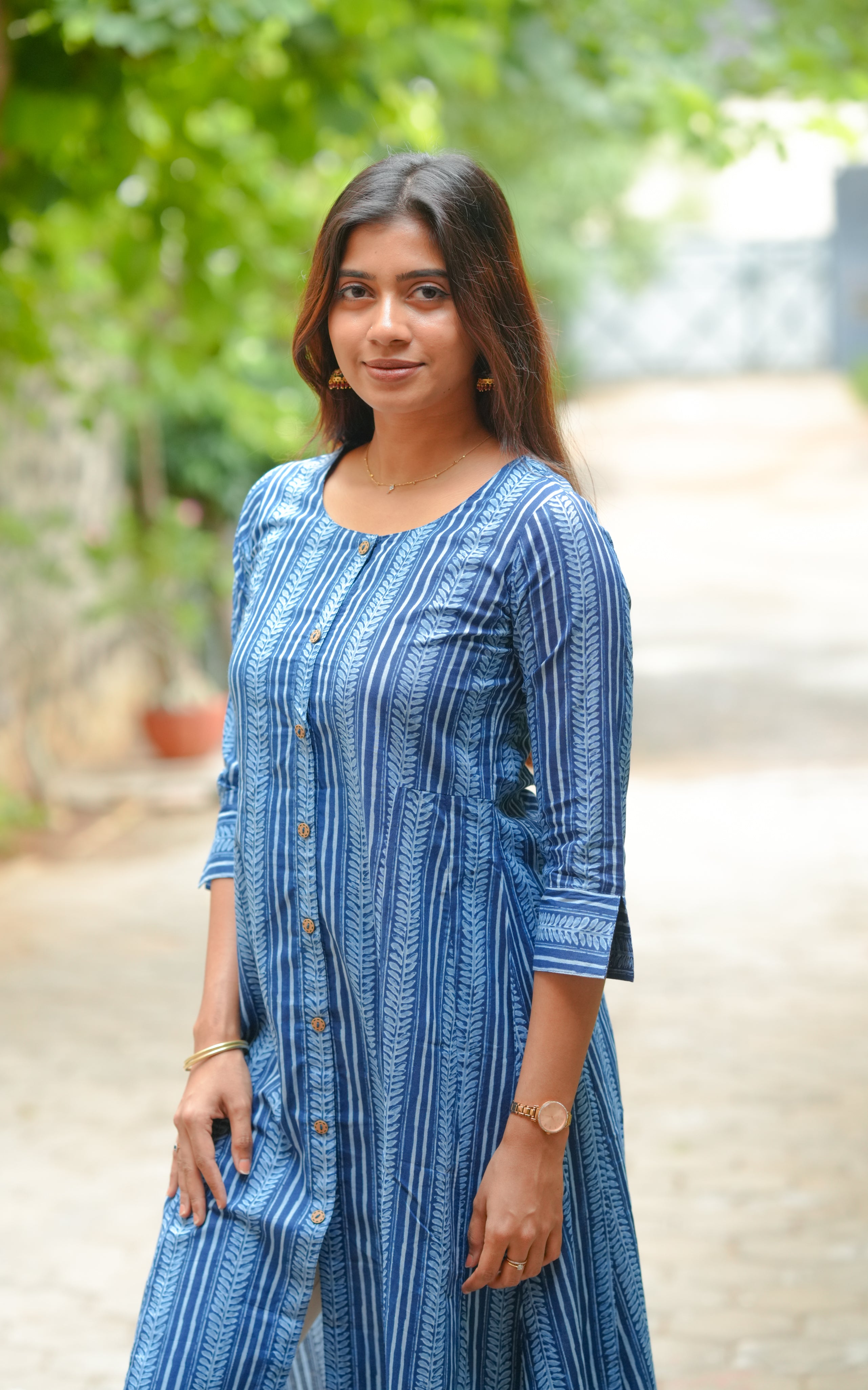 It features a front slit and a button-down design.