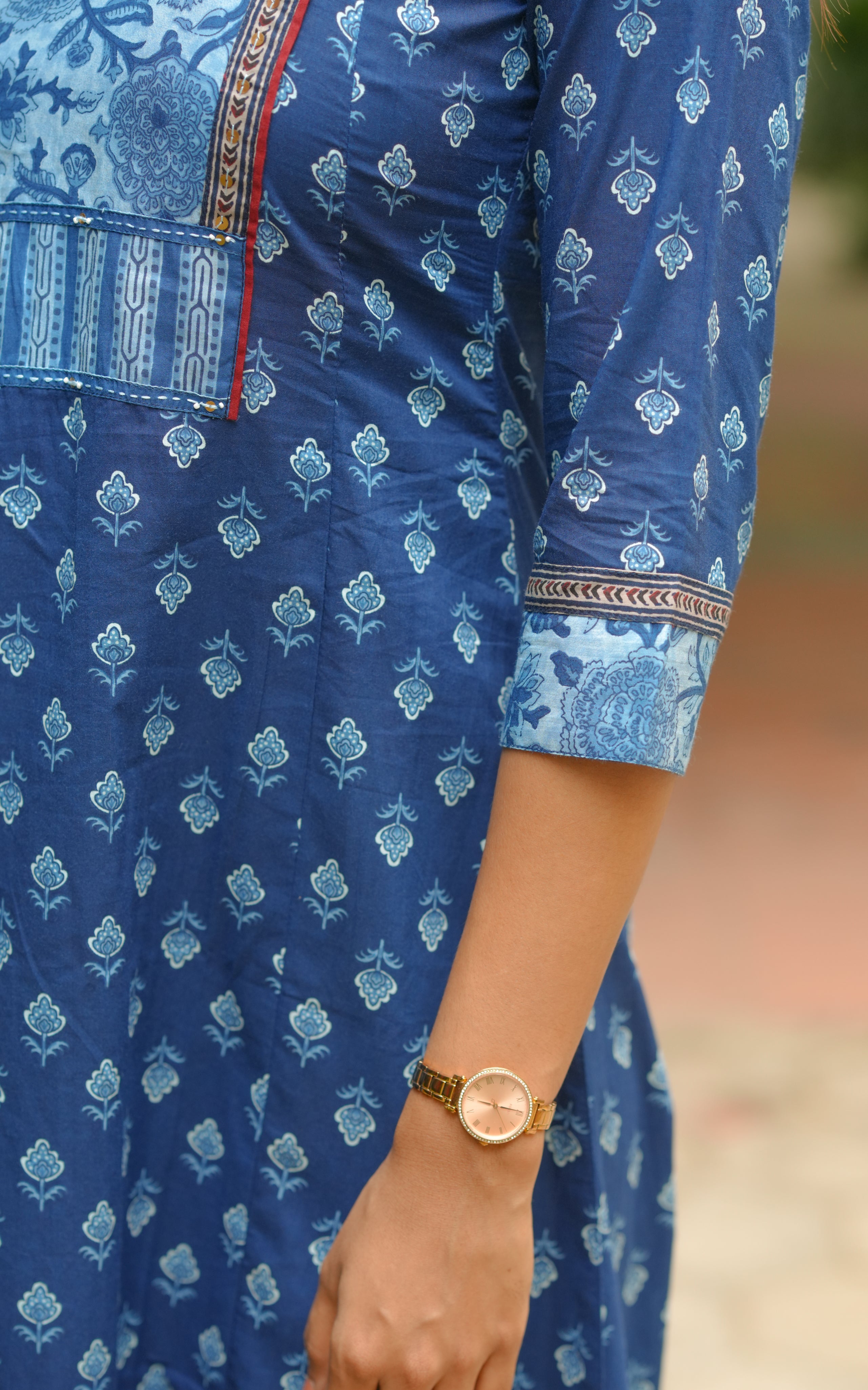 Subtle red piping along the yoke elevates the neckline design.