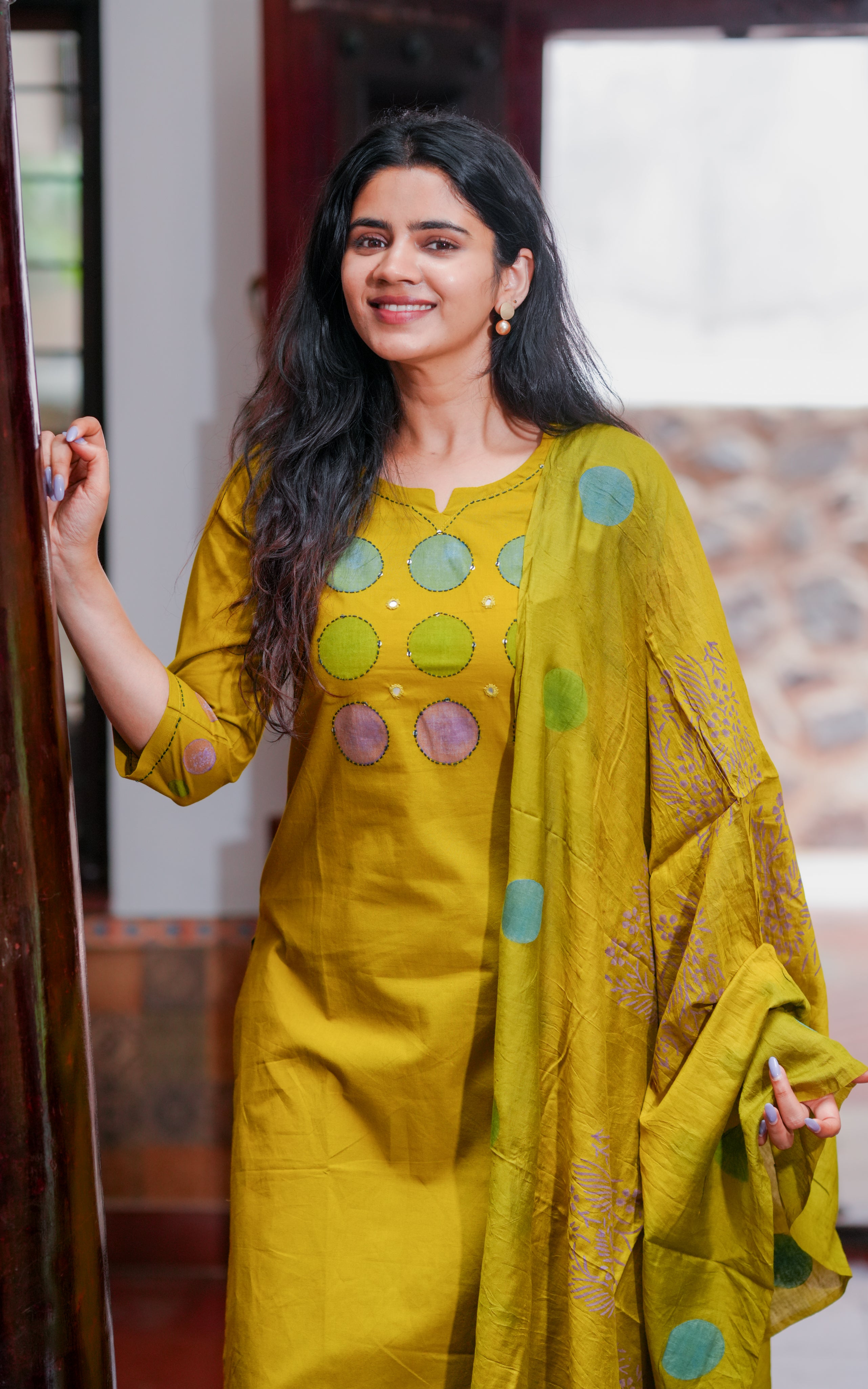 Kurti is decorated with colorful handblock printed circles on the front.