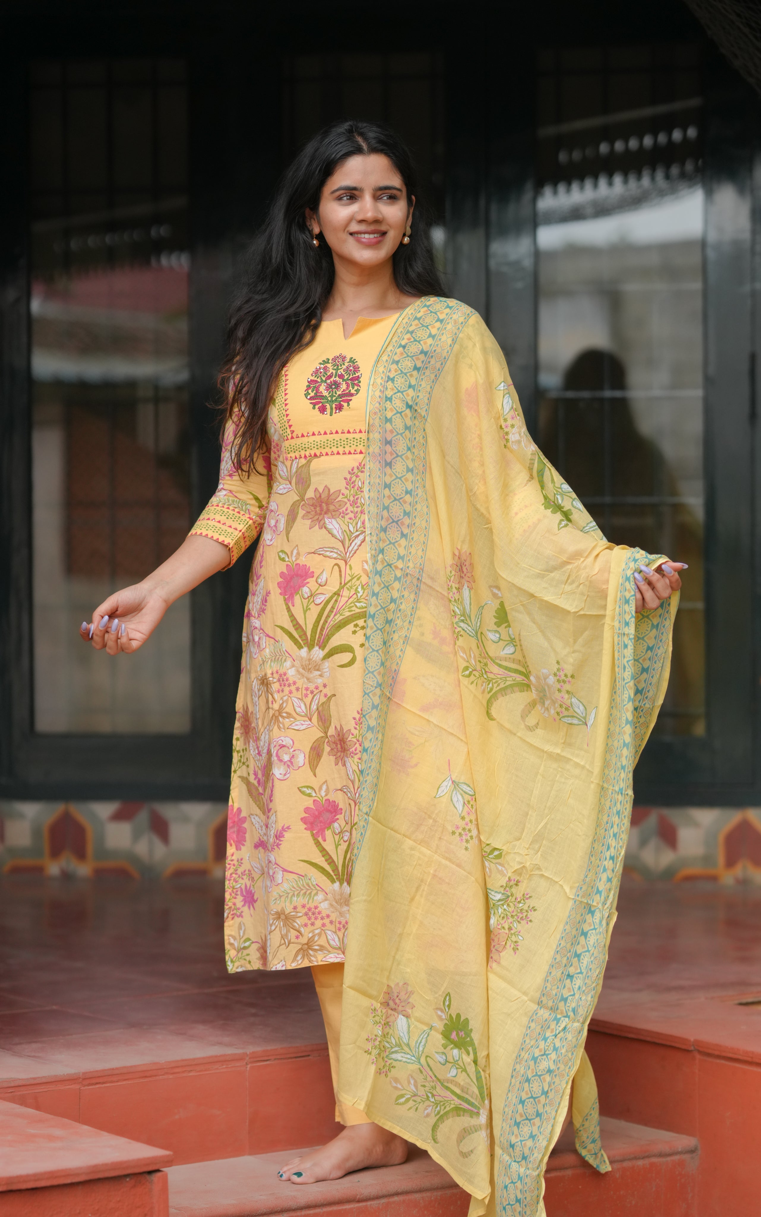 Beautiful floral prints in pink, green, and beige tones on the kurti and dupatta.