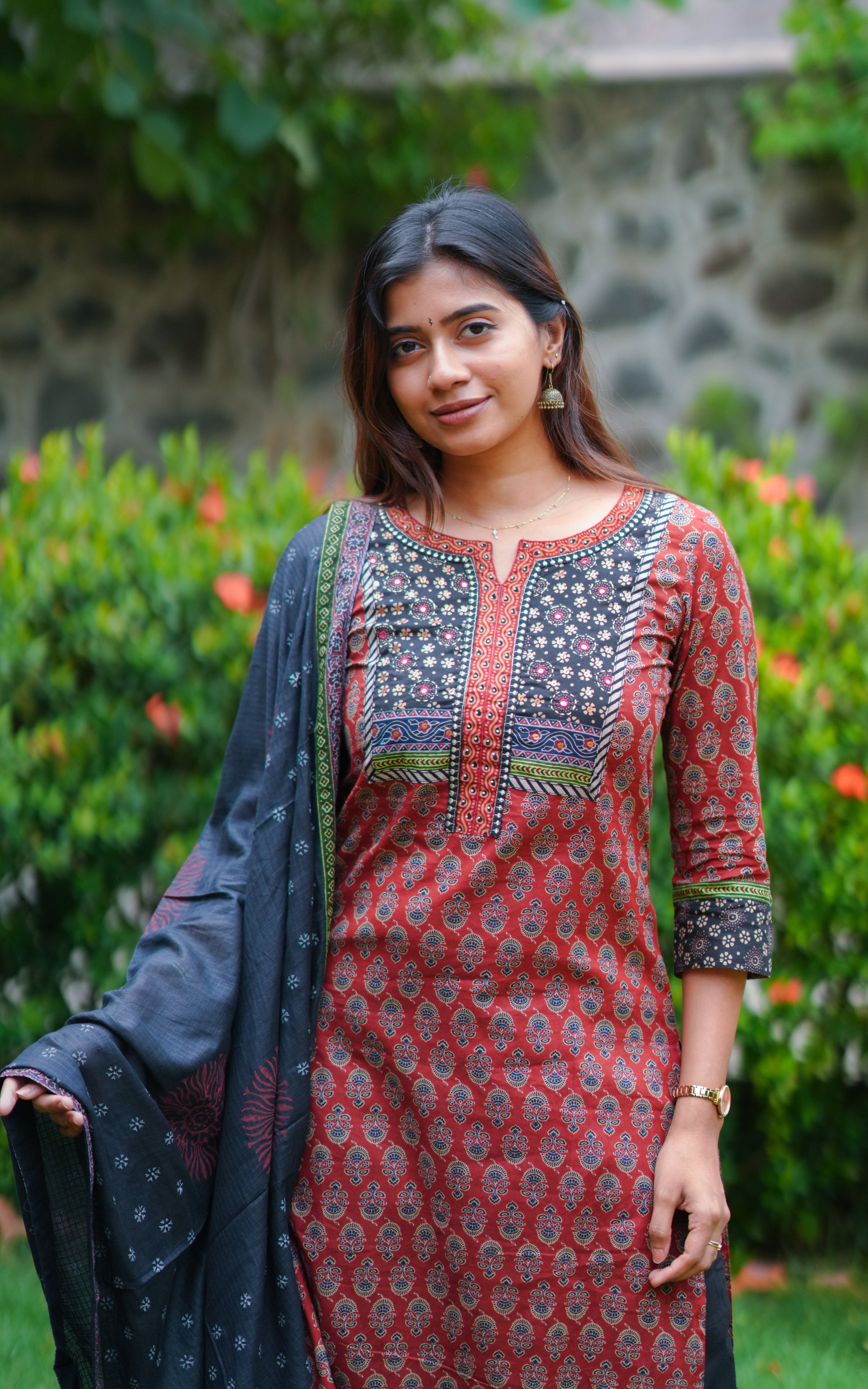 Woman wearing a rust-colored printed cotton straight cut kurti.