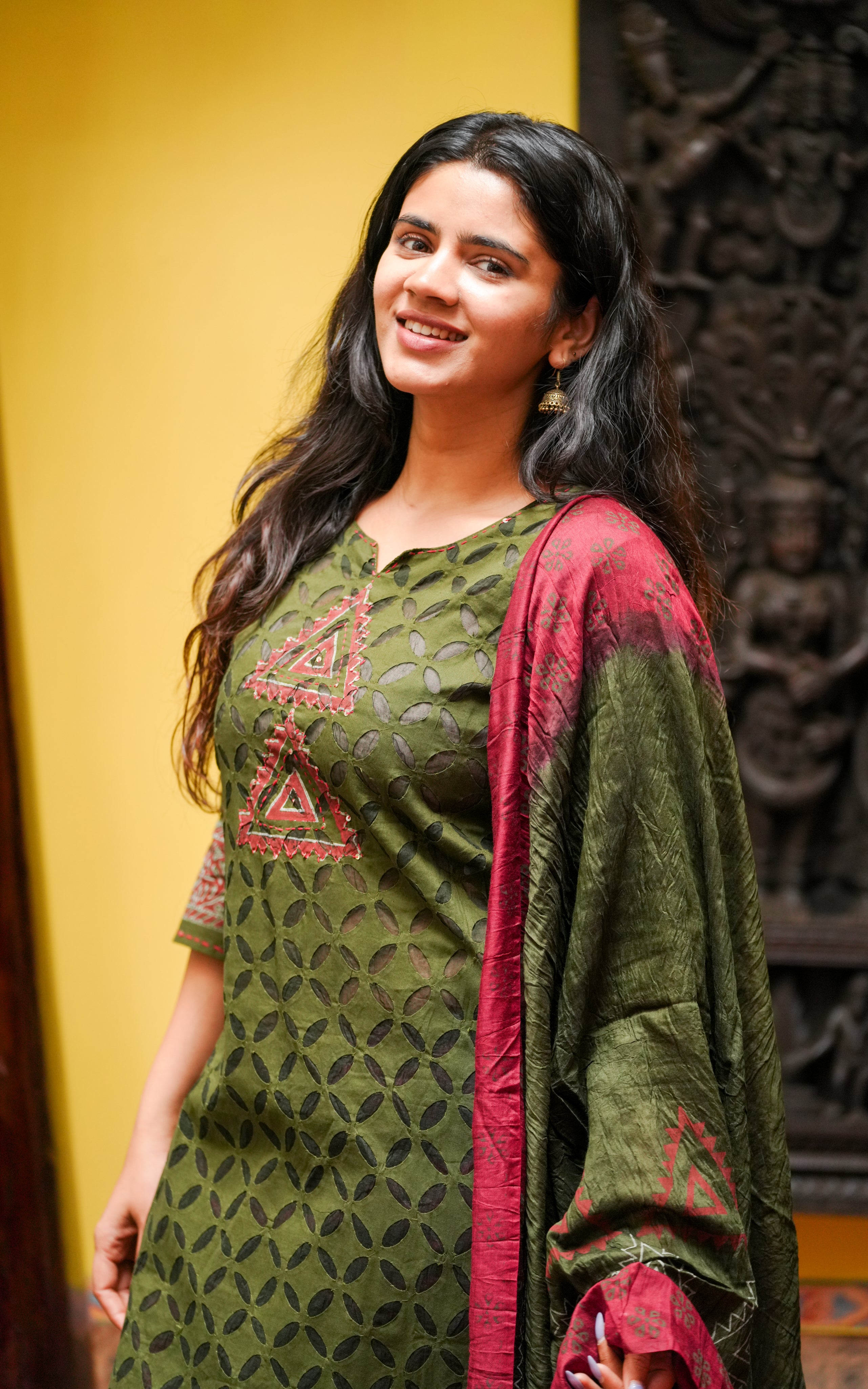 Intricate triangle applique motifs on the yoke enhance the ethnic charm.