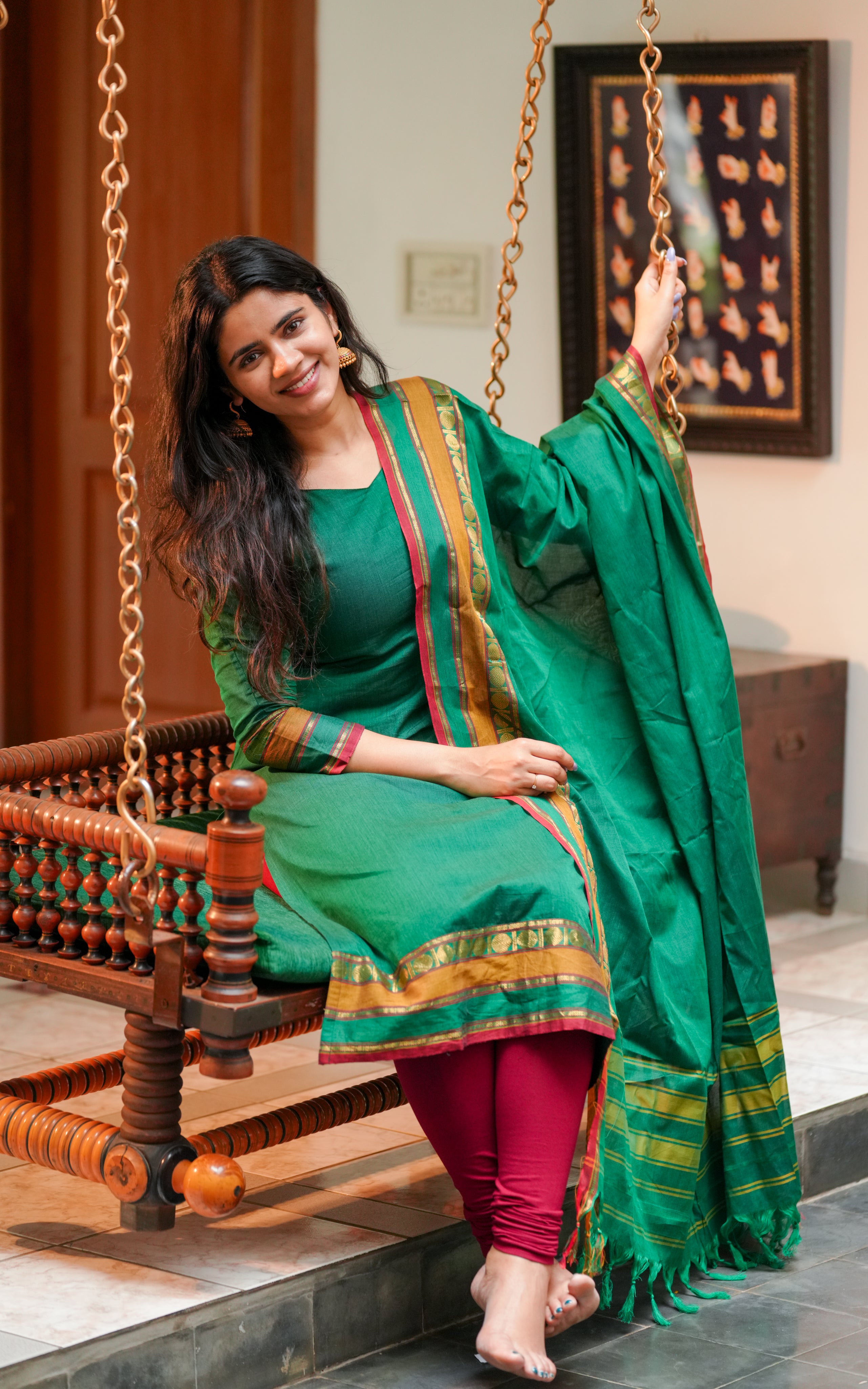 Paired with a matching bottle green dupatta for a coordinated look.