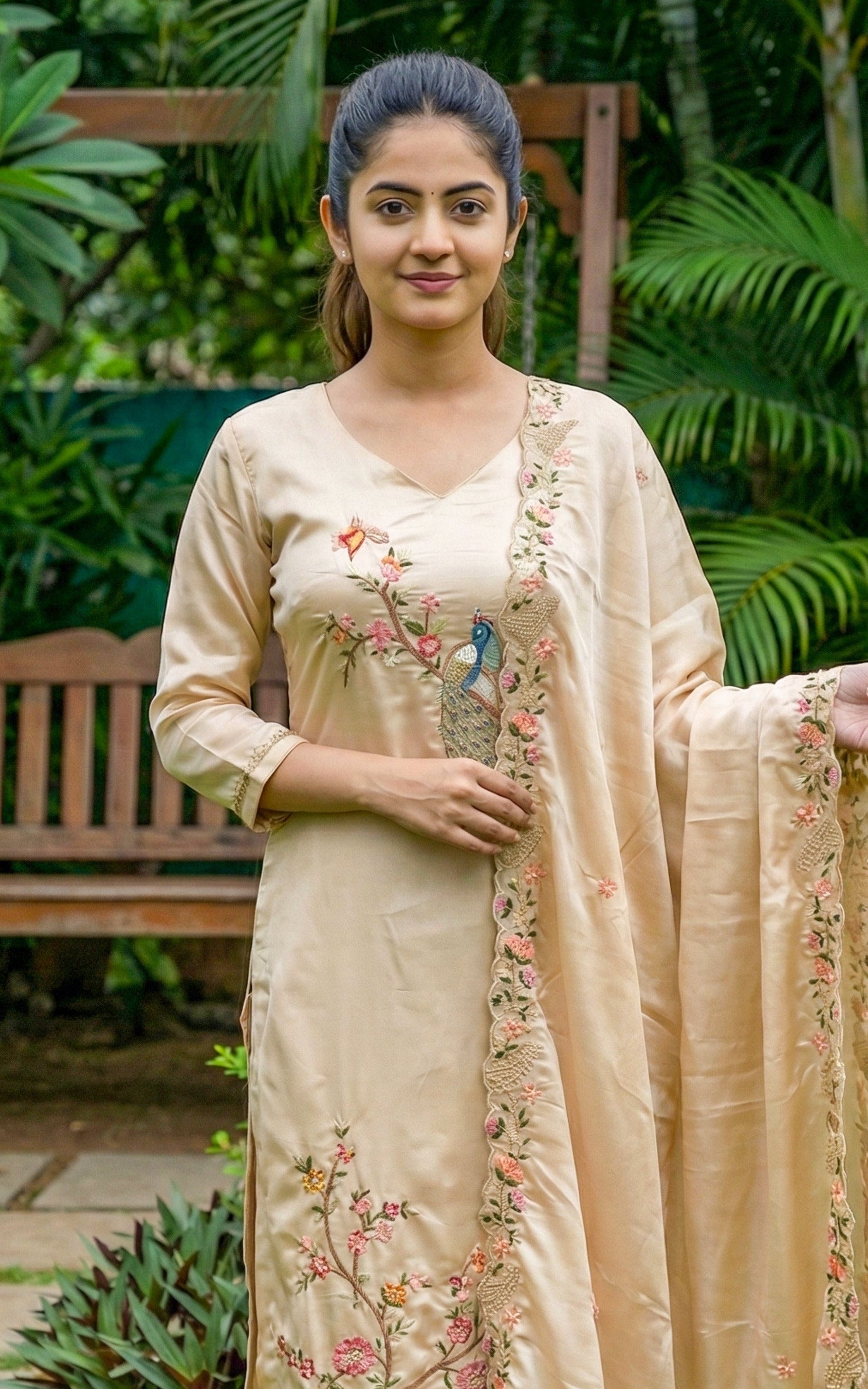 Woman wearing a beige traditional outfit with floral embroidery