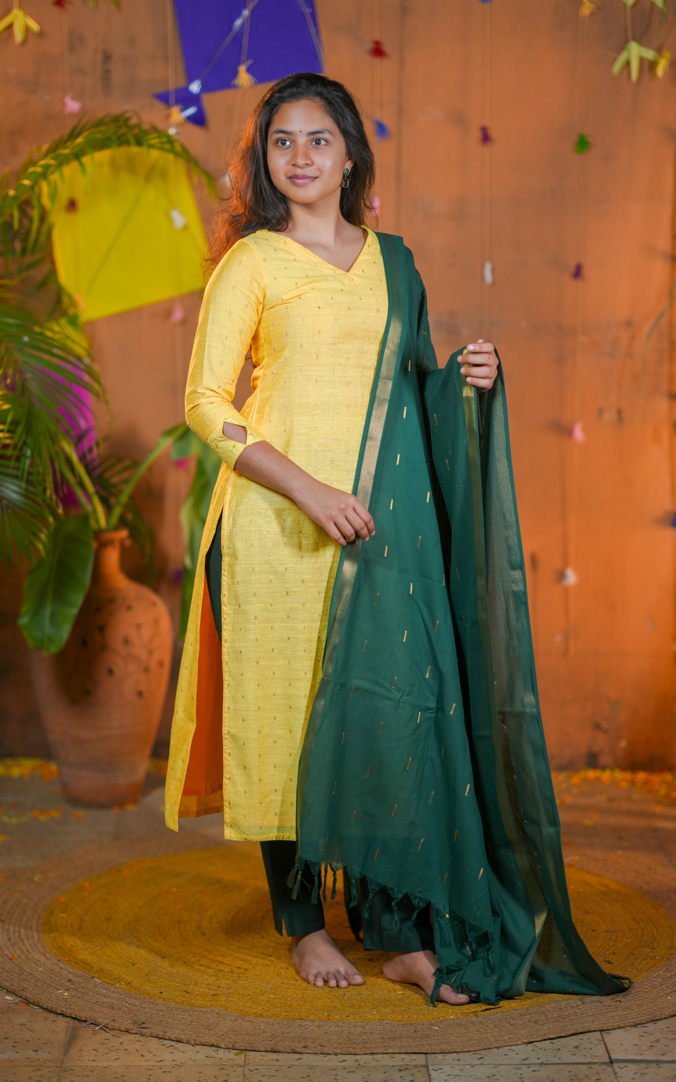 Woman in yellow kurta with green dupatta