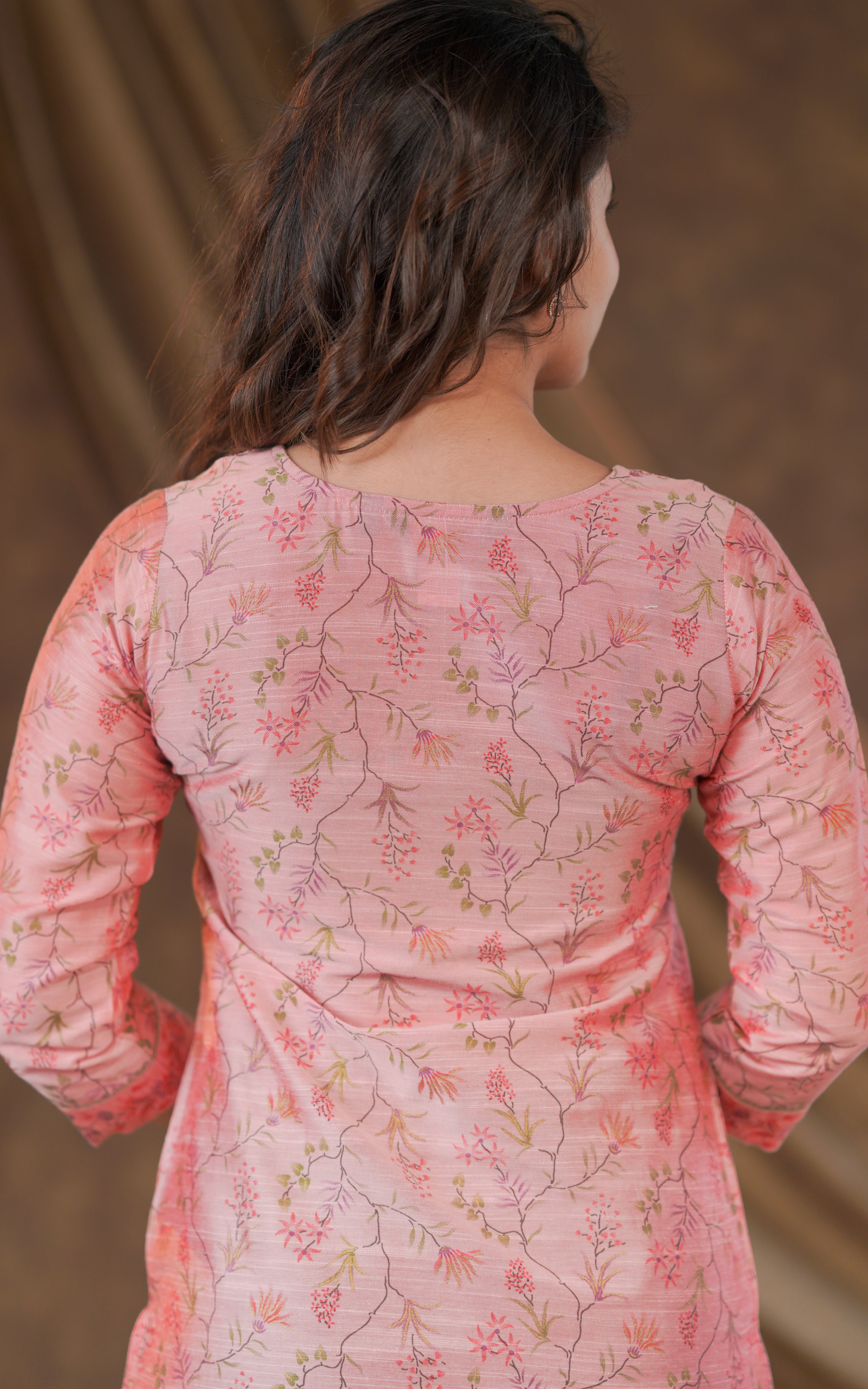 Dark green straight pants provide a perfect contrast to the pastel kurti.

Comfortable wedge sandals complete the outfit with a trendy touch