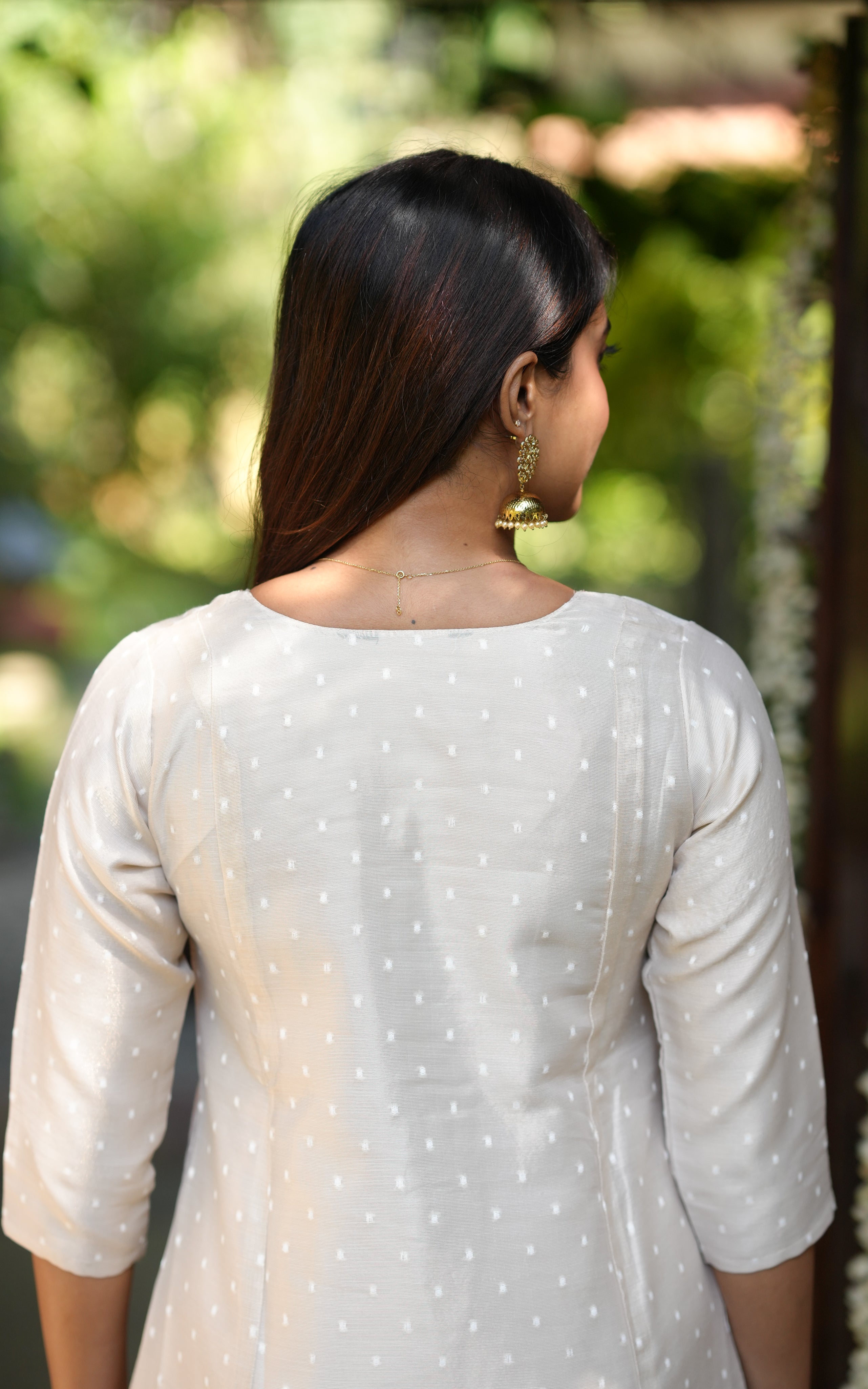 Back neckline features a modest round shape