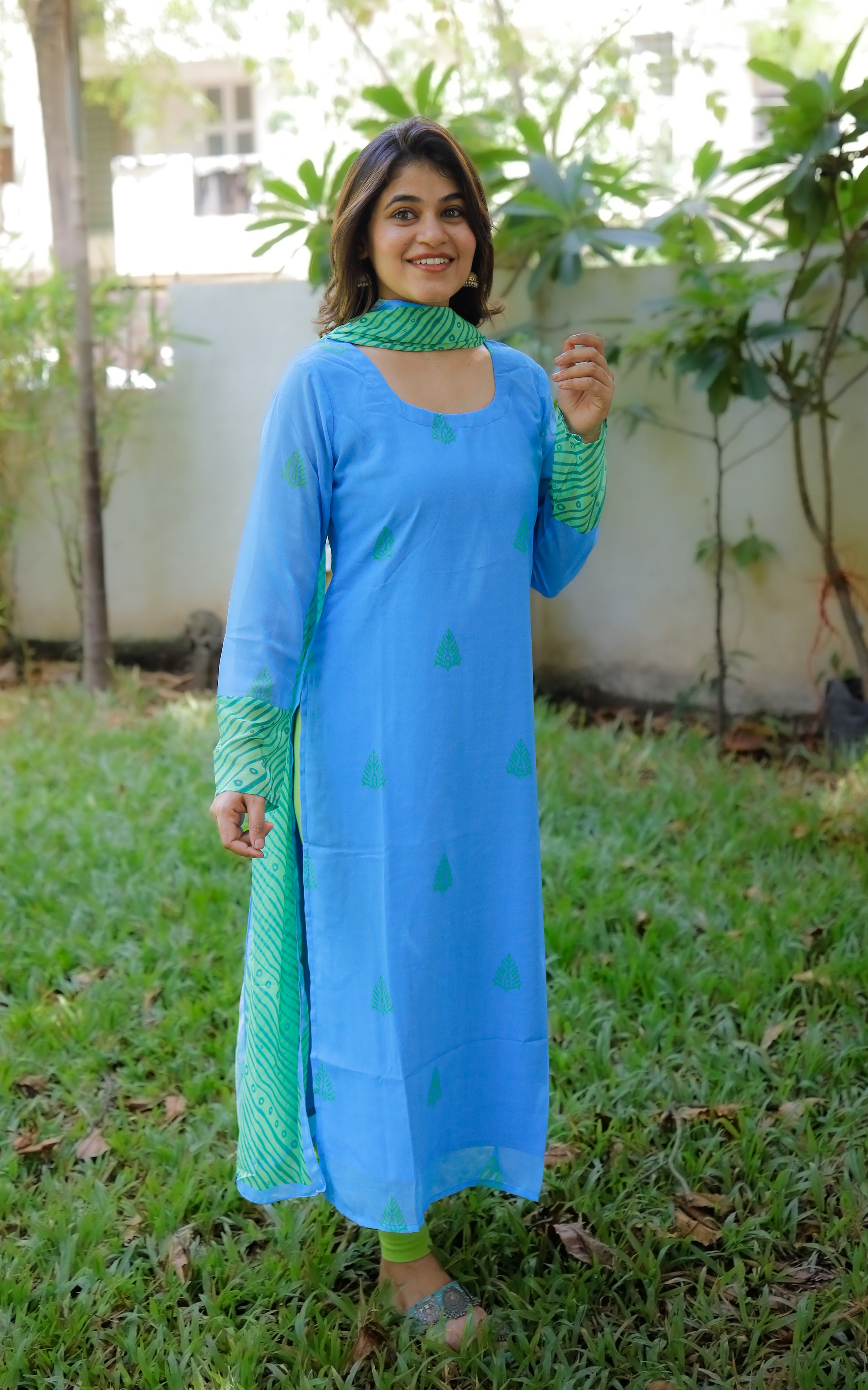 Sleeves are blue with green printed cuffs